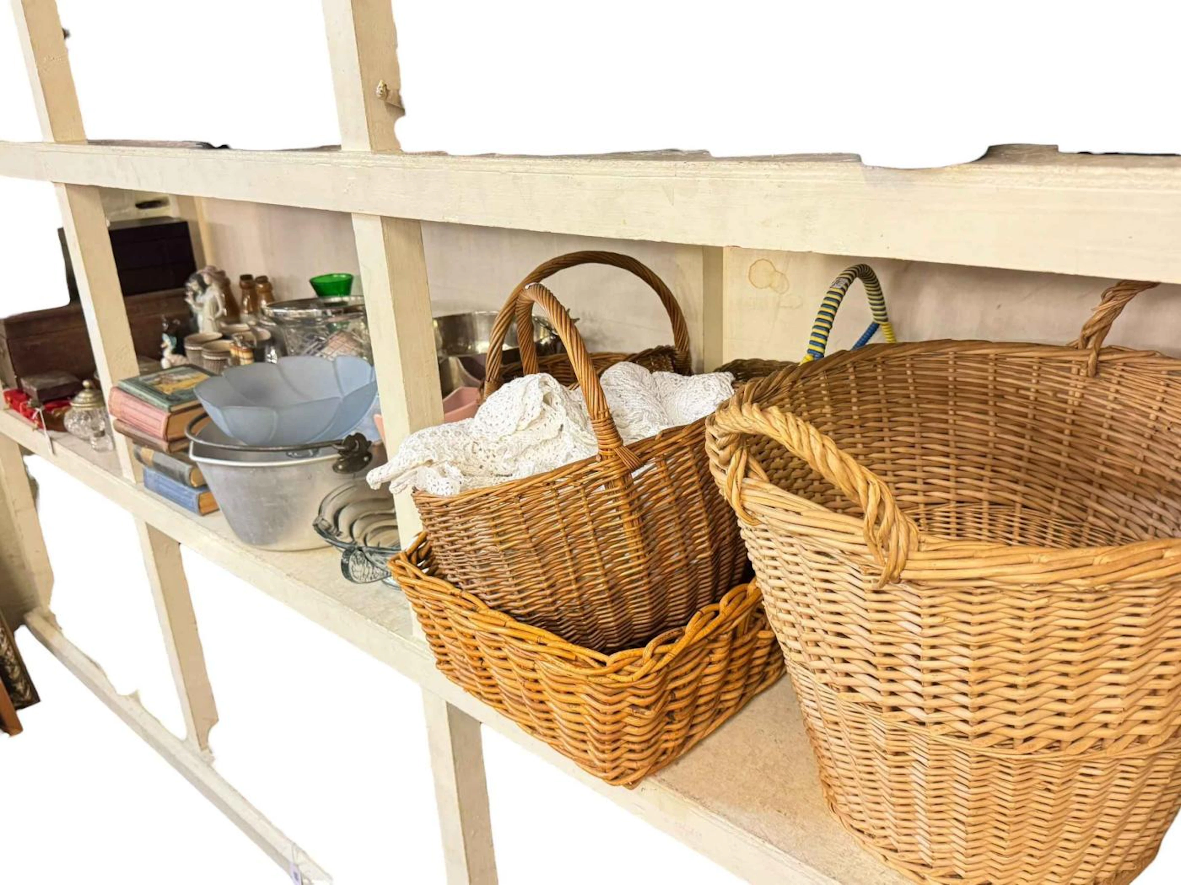 Full shelf of china, doll, wicker baskets, boxes, mirrors, pictures, etc.