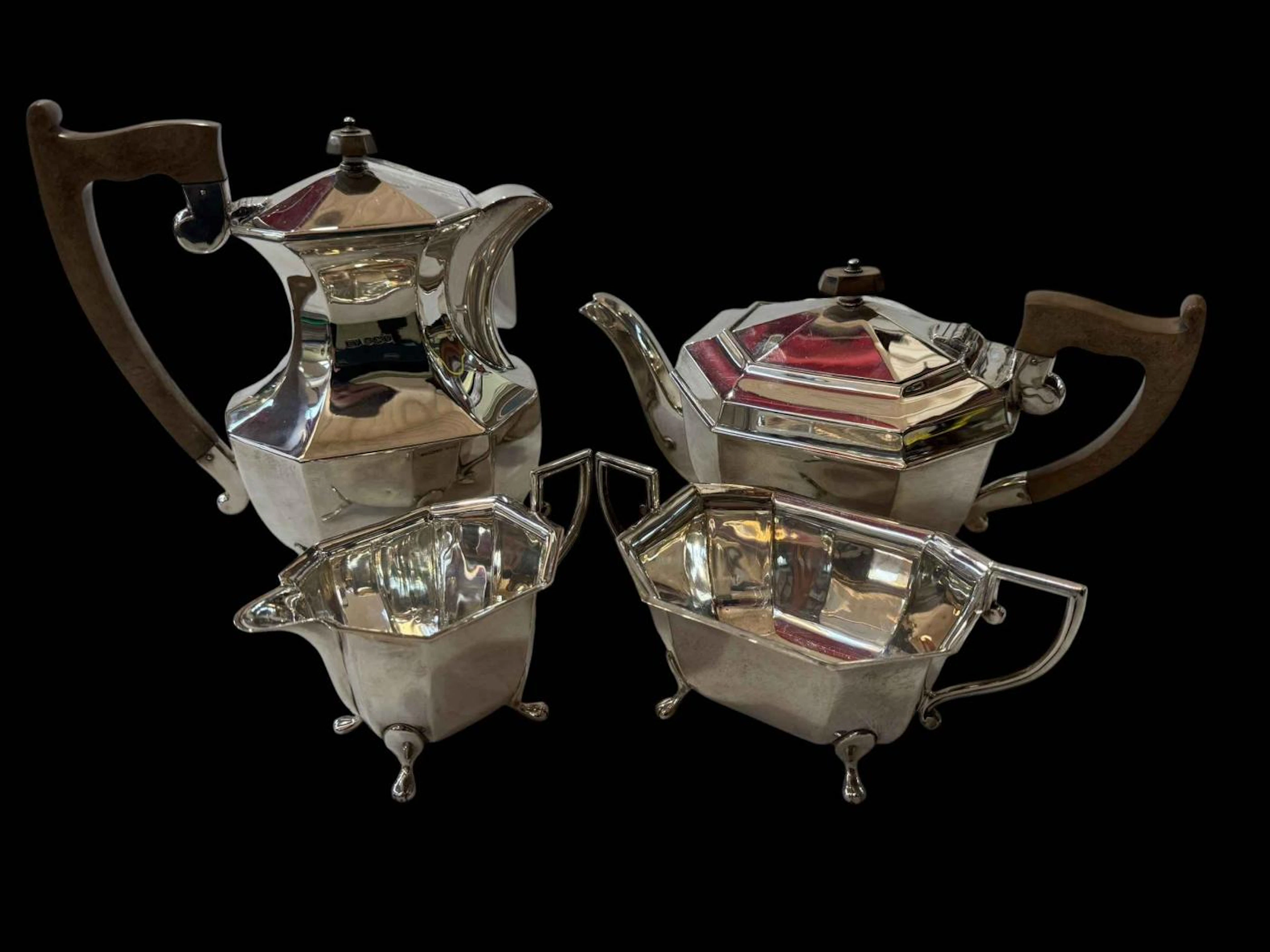 Silver four piece tea set, the octagonal bodies on paw feet, Sheffield 1938.