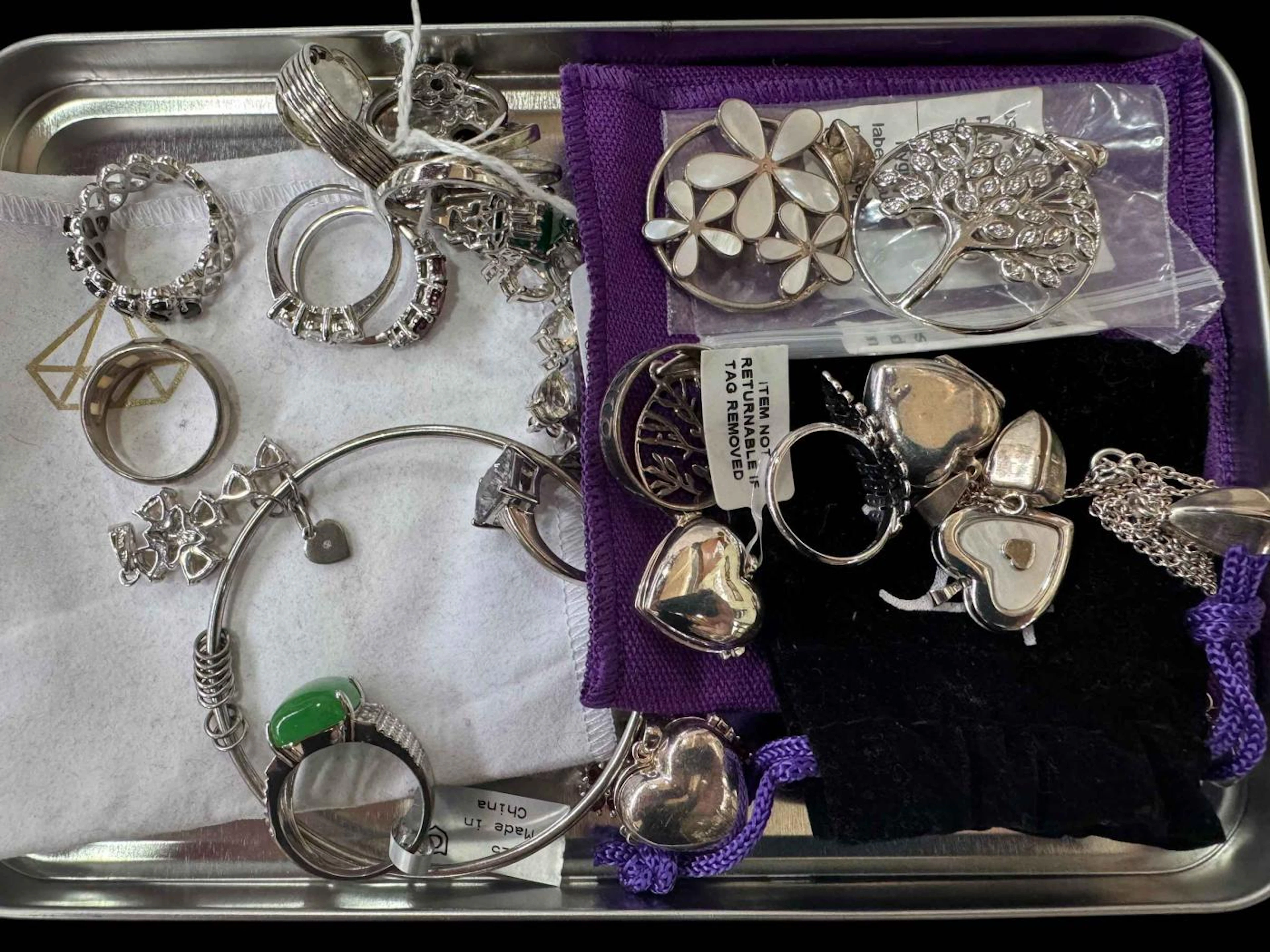 Collection of silver jewellery including rings, pendants and gem set pieces.