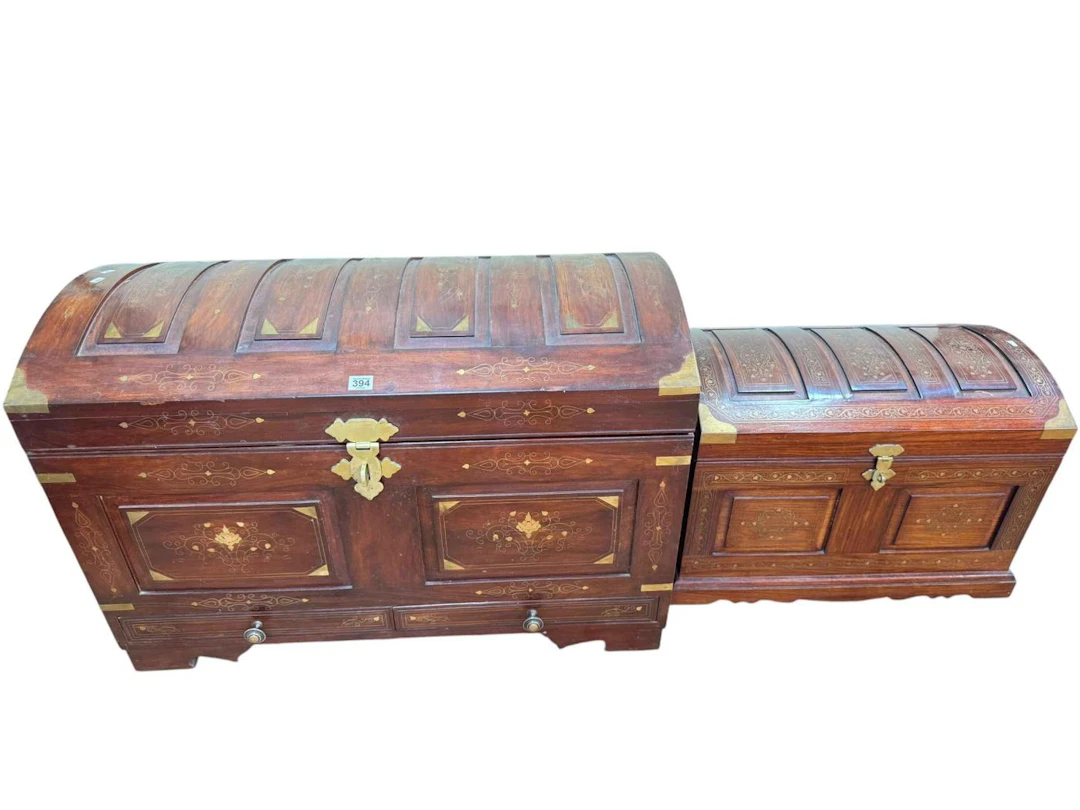 Large and small eastern brass inlaid hardwood dome topped trunks with