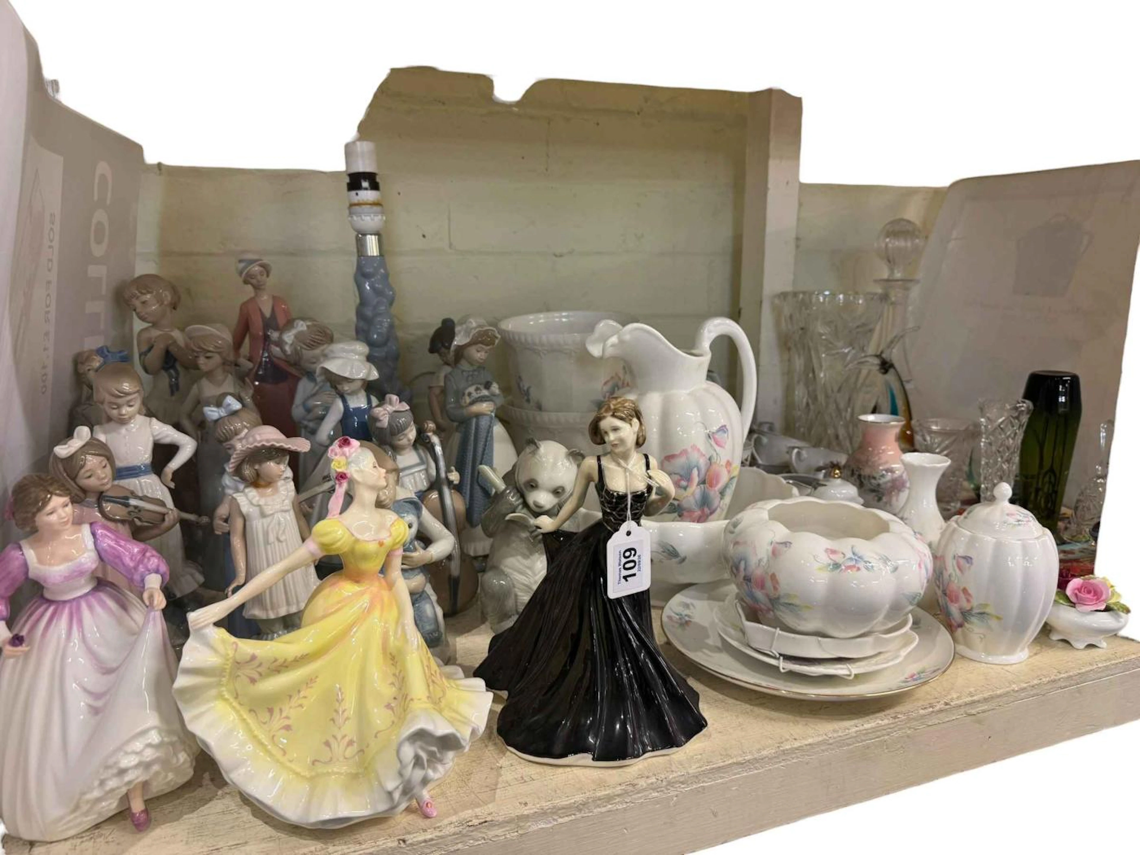 Fifteen Nao figures including a table lamp, three Royal Doulton ladies