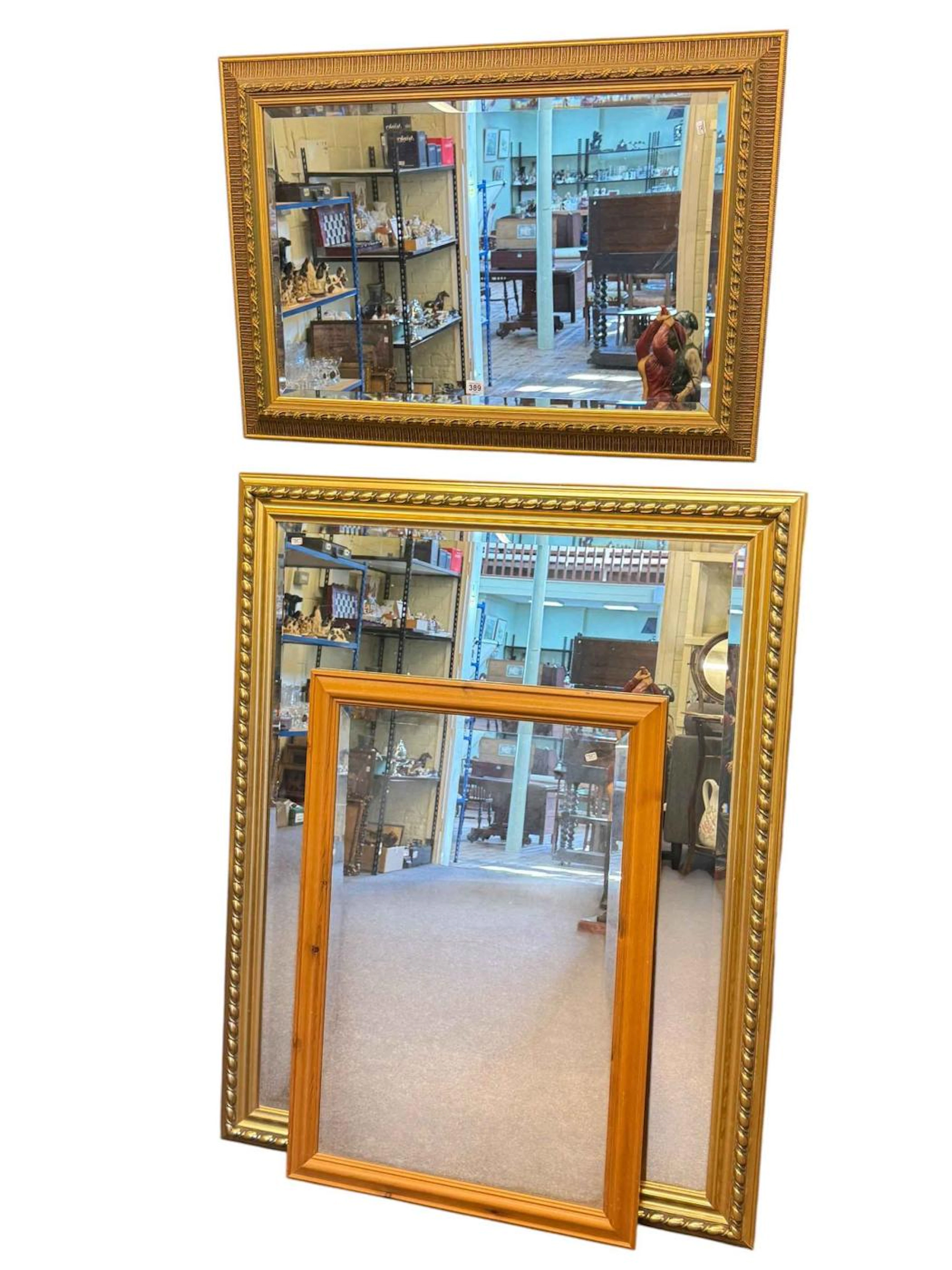 Two gilt framed bevelled wall mirrors and pine framed mirror.