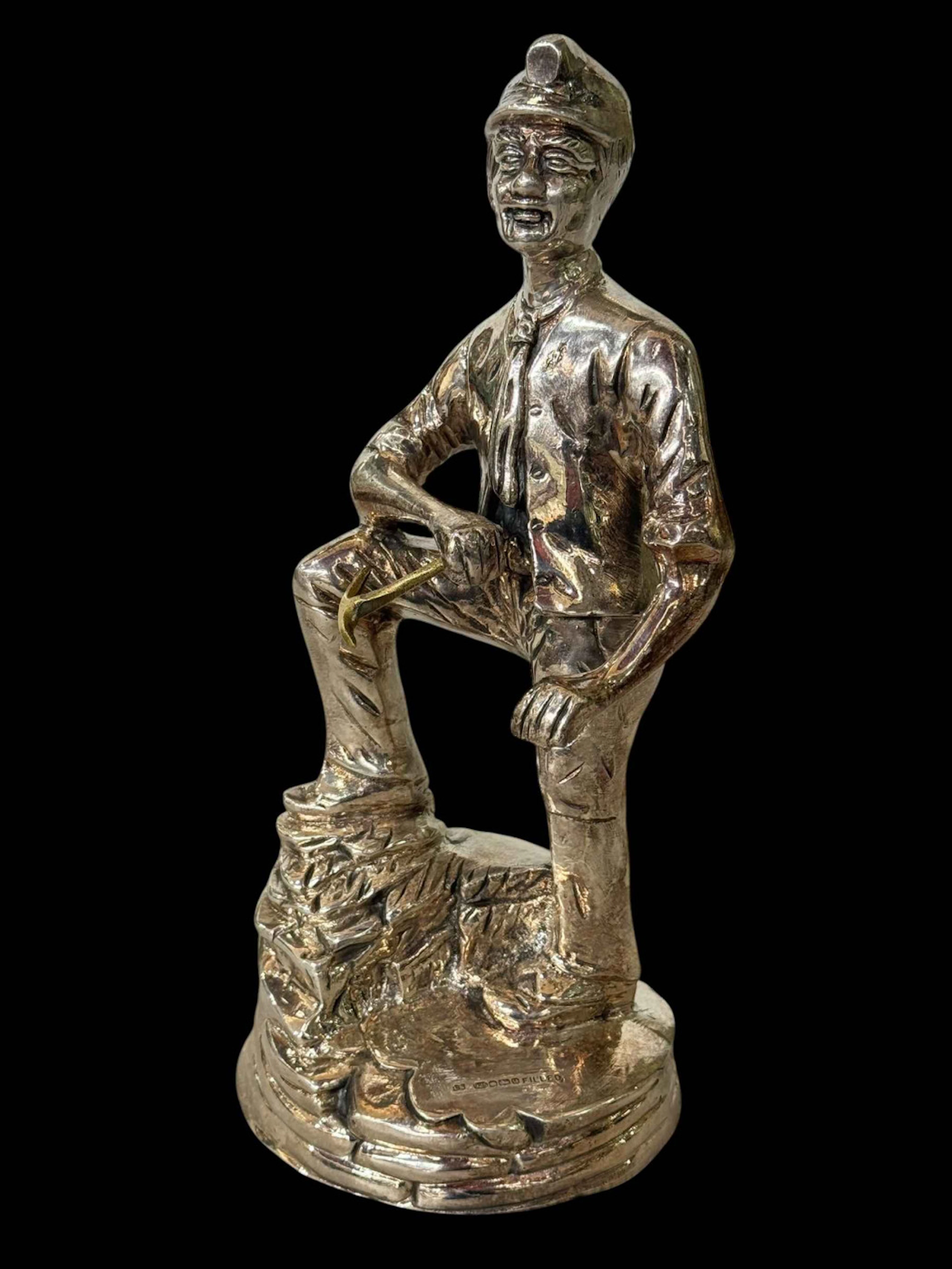 Sterling silver filled model of a miner with pick, Sheffield 2015, 28cm.