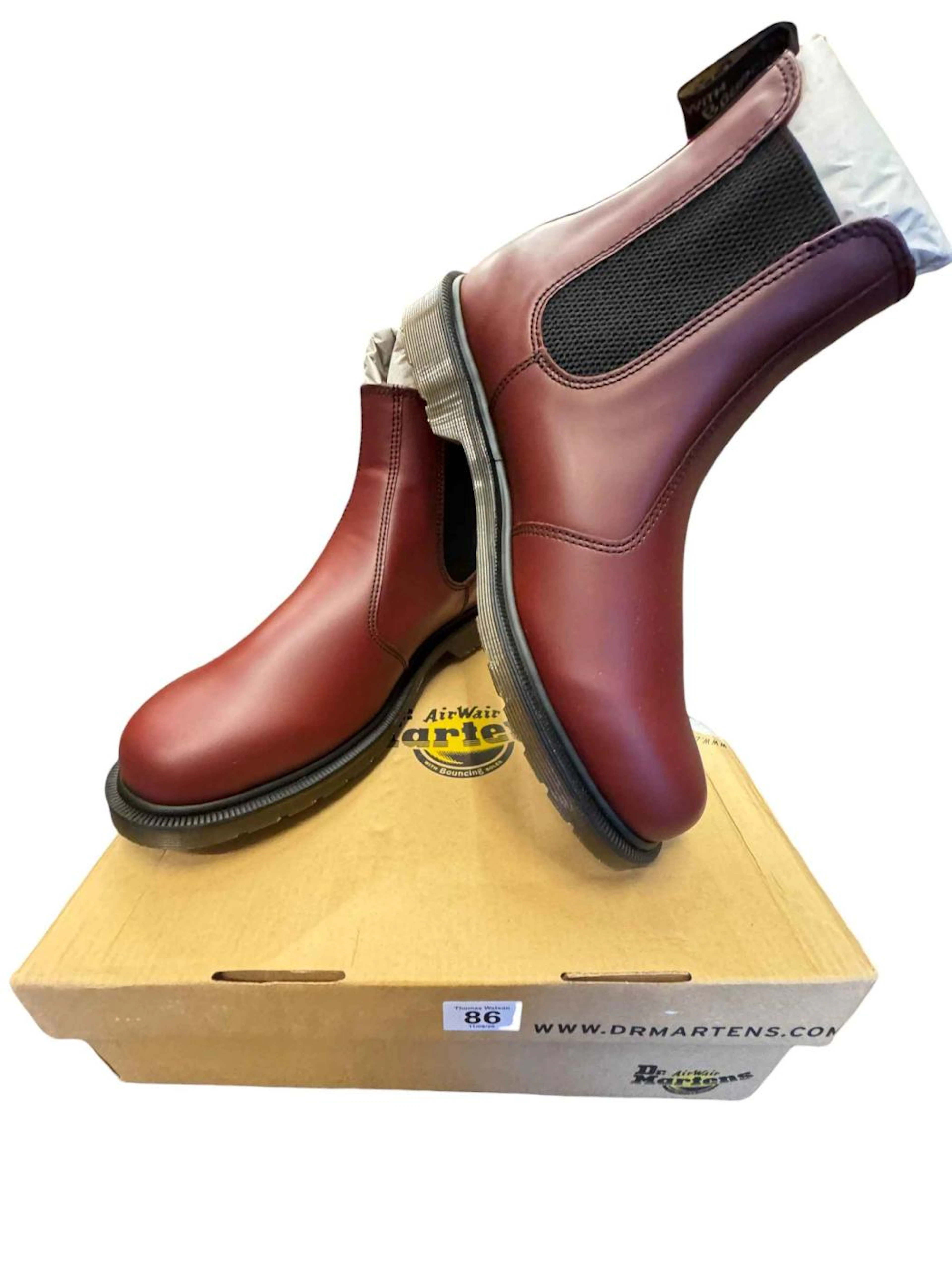 Seven pairs of cherry red Dr Martens rider style boots.