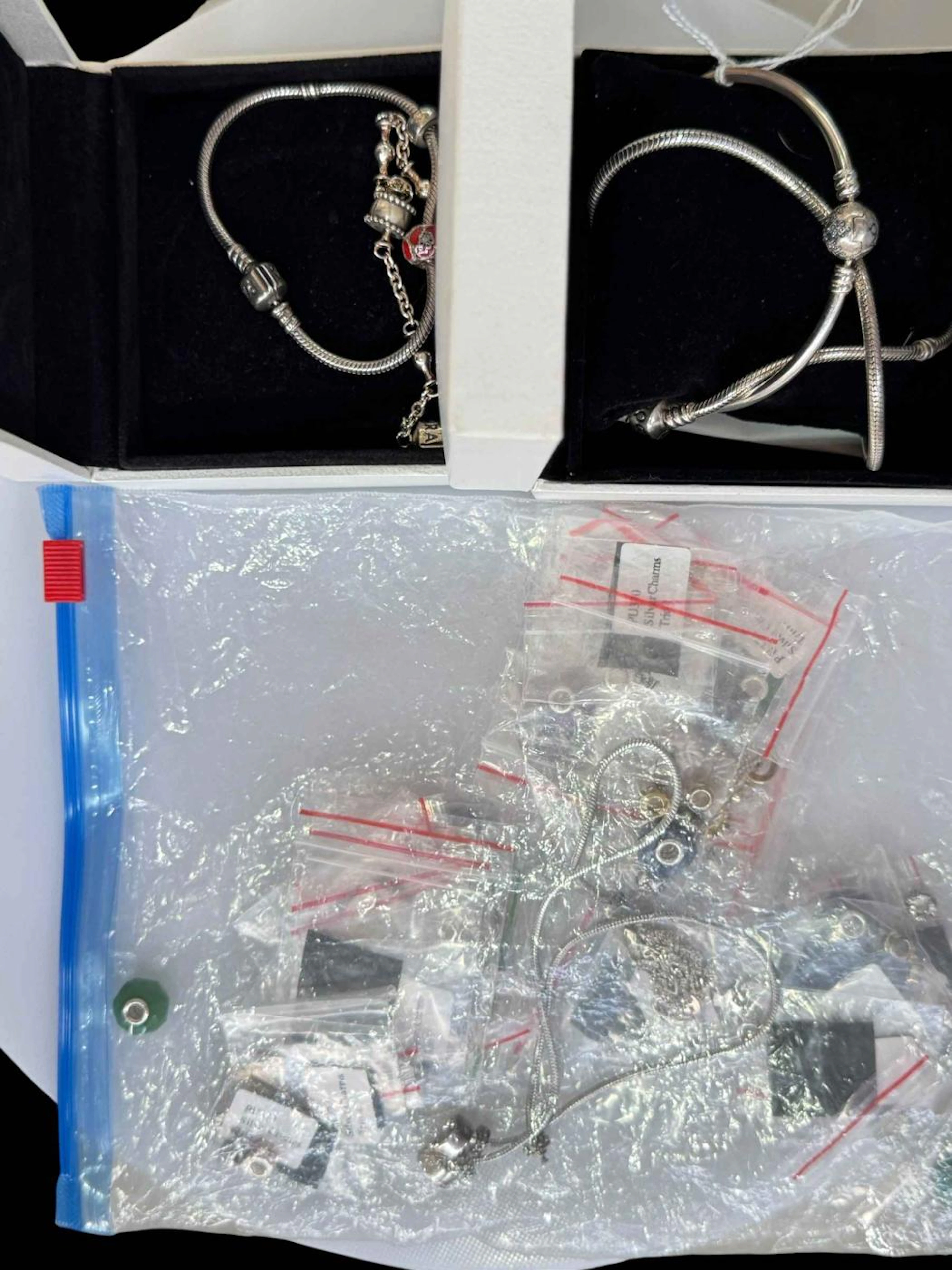 Three Pandora bracelets, necklace and charms.