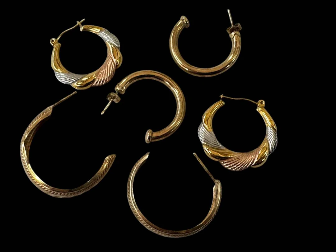 Three pair of 9 carat gold earrings.