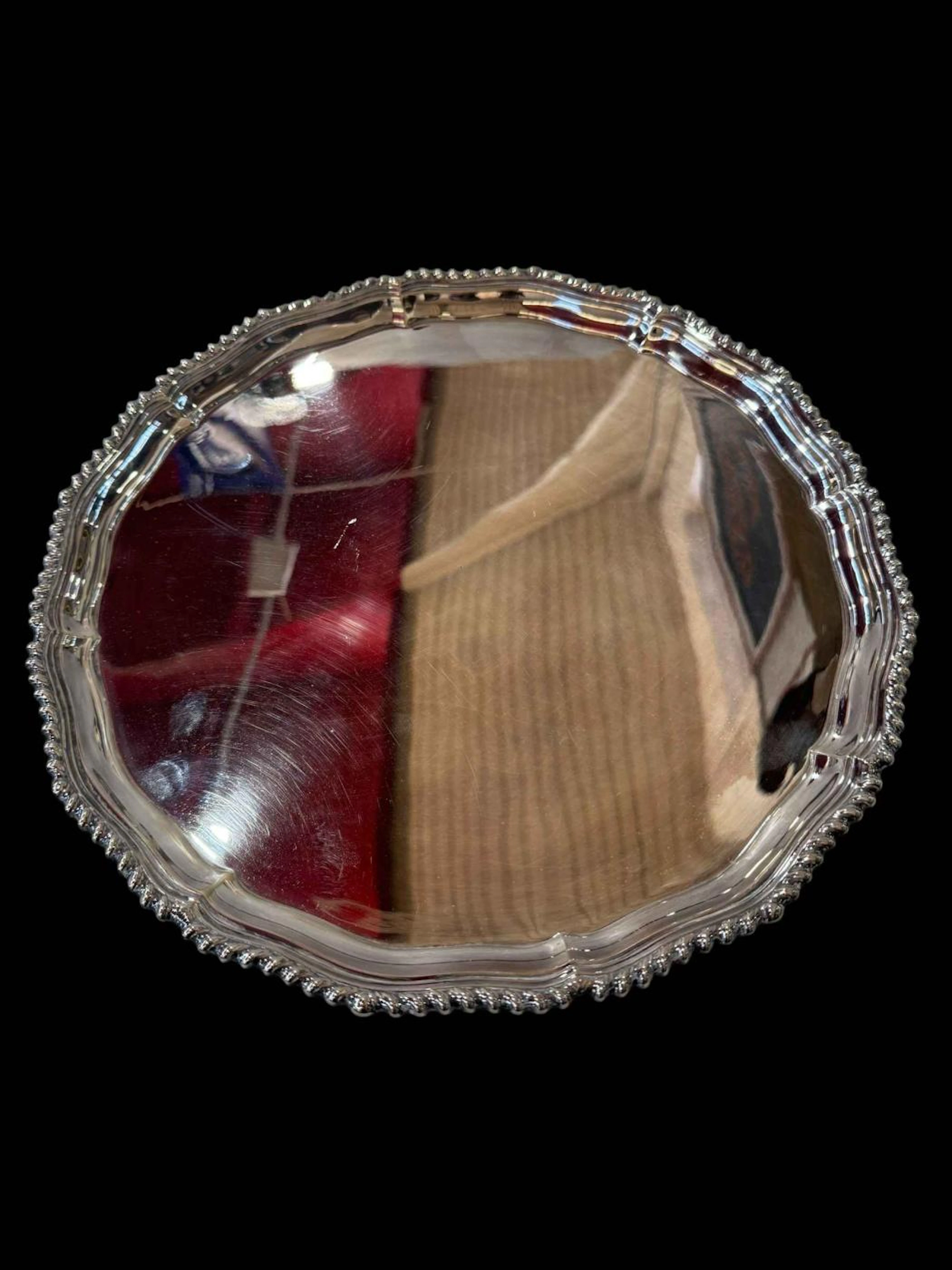 Silver salver with gadroon border and on scroll feet, Sheffield 1976