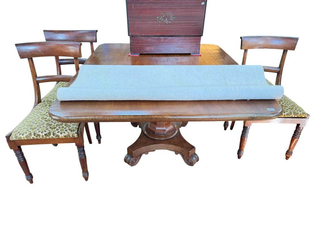 Mahogany pedestal dining table featuring a central octagonal column