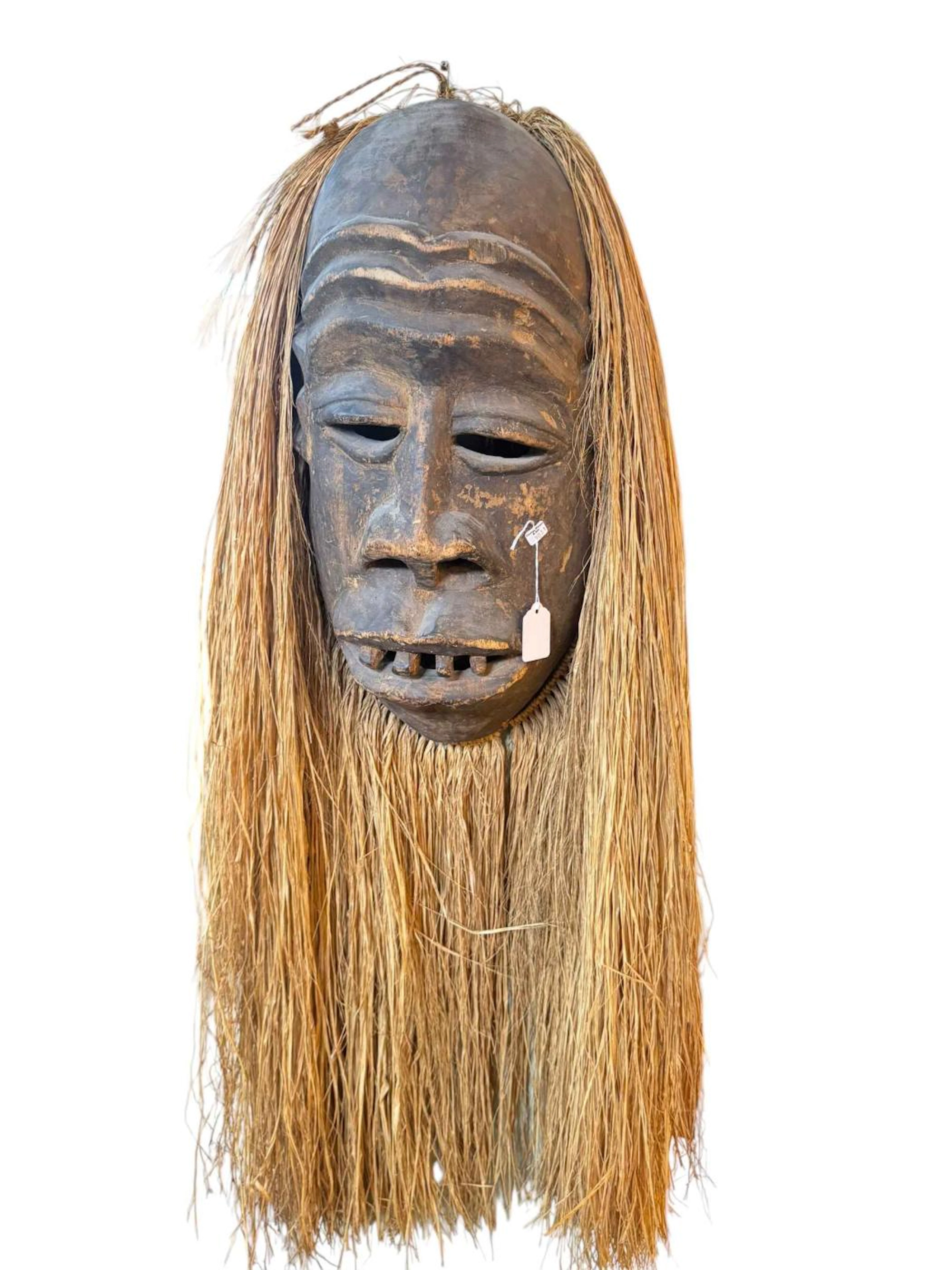 Large African tribe carved face mask, three others carved family tree