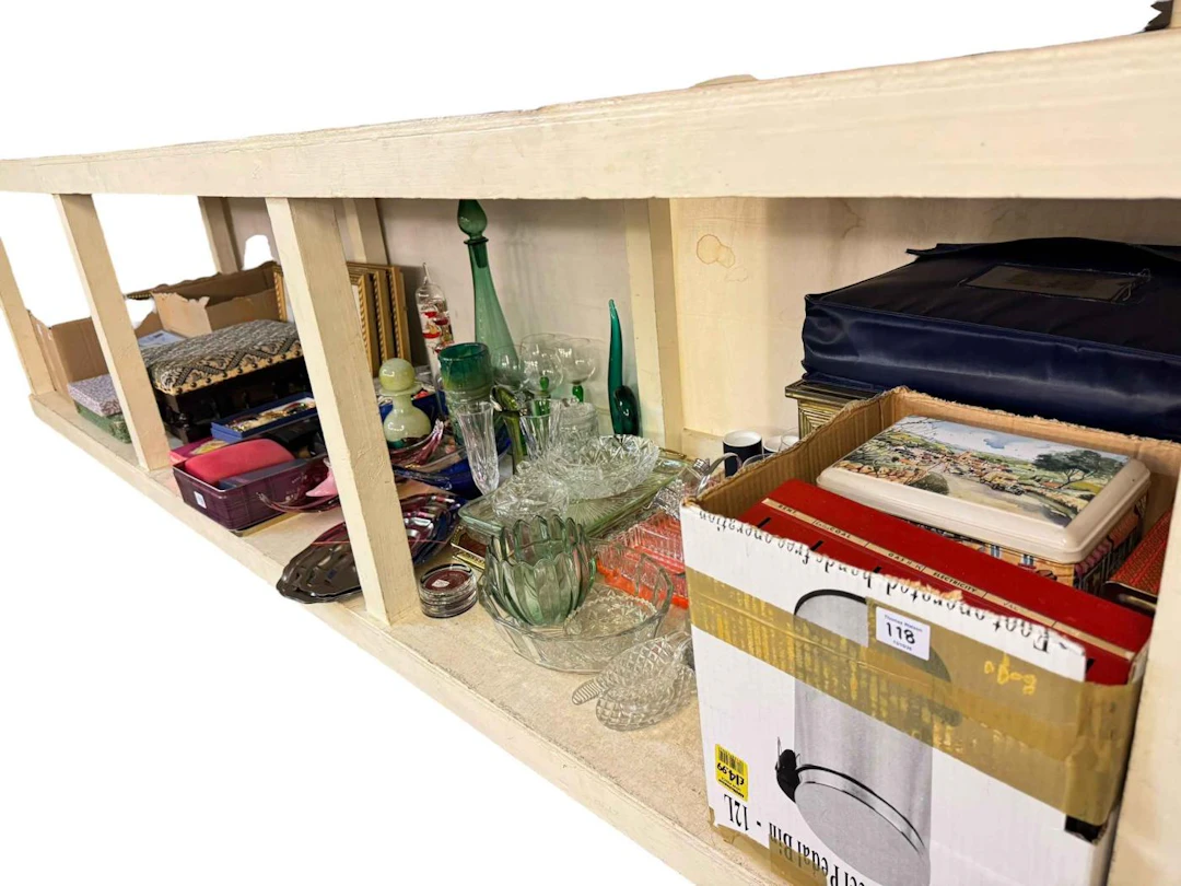 Full shelf of costume jewellery, glassware, tins, brass log bin, stool