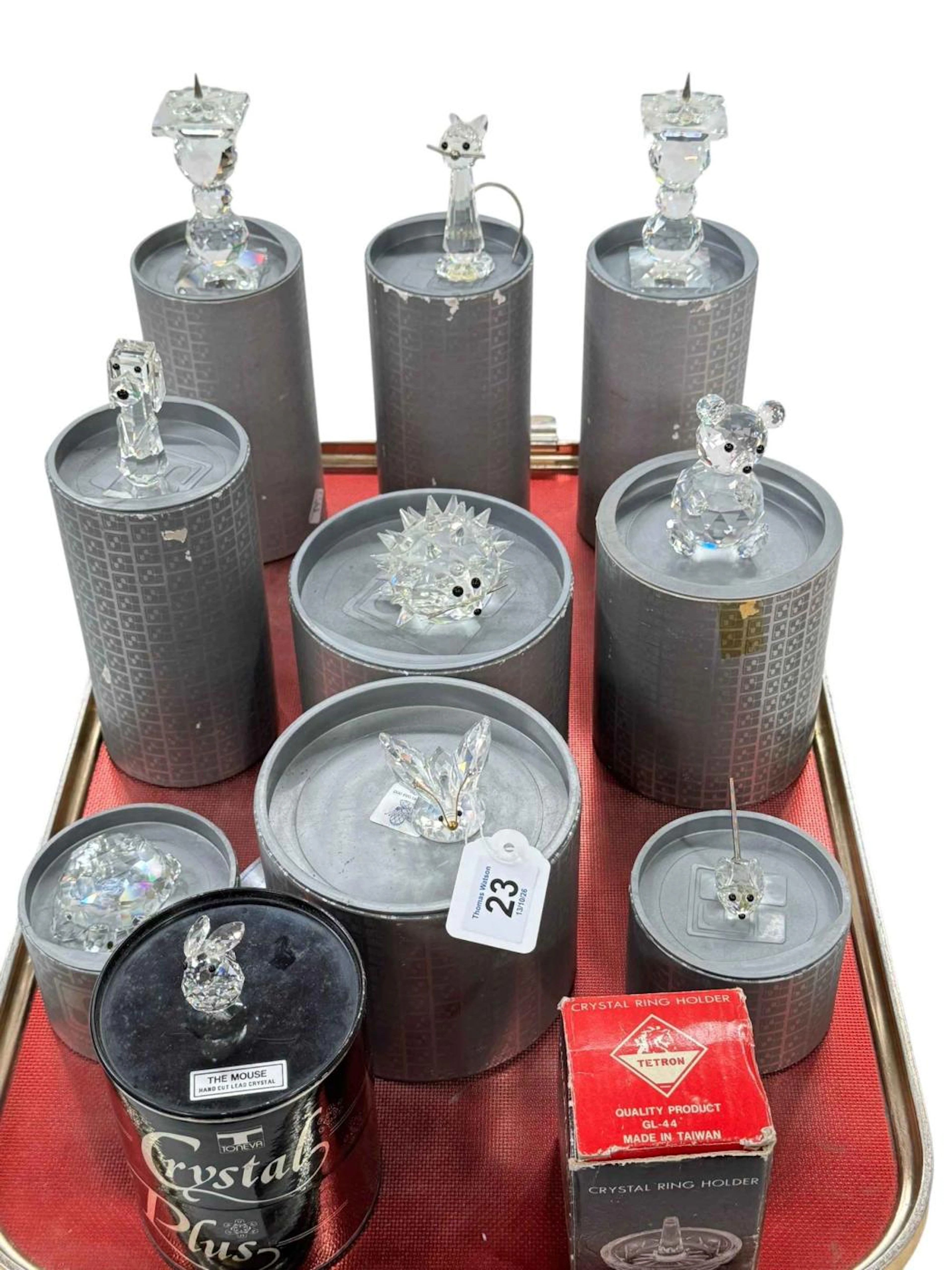 Ten Swarovski pieces with boxes and crystal ring stand (11).