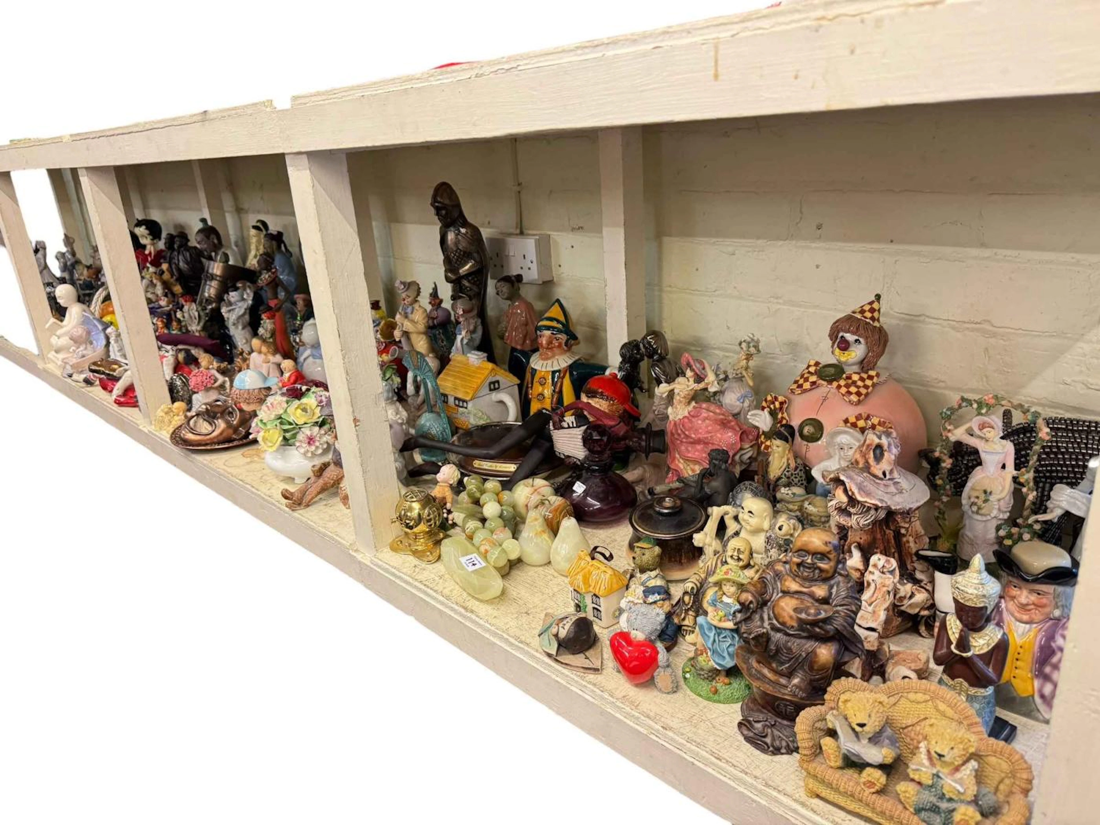 Full shelf of clown and other ornaments, model vehicles, Laurel &