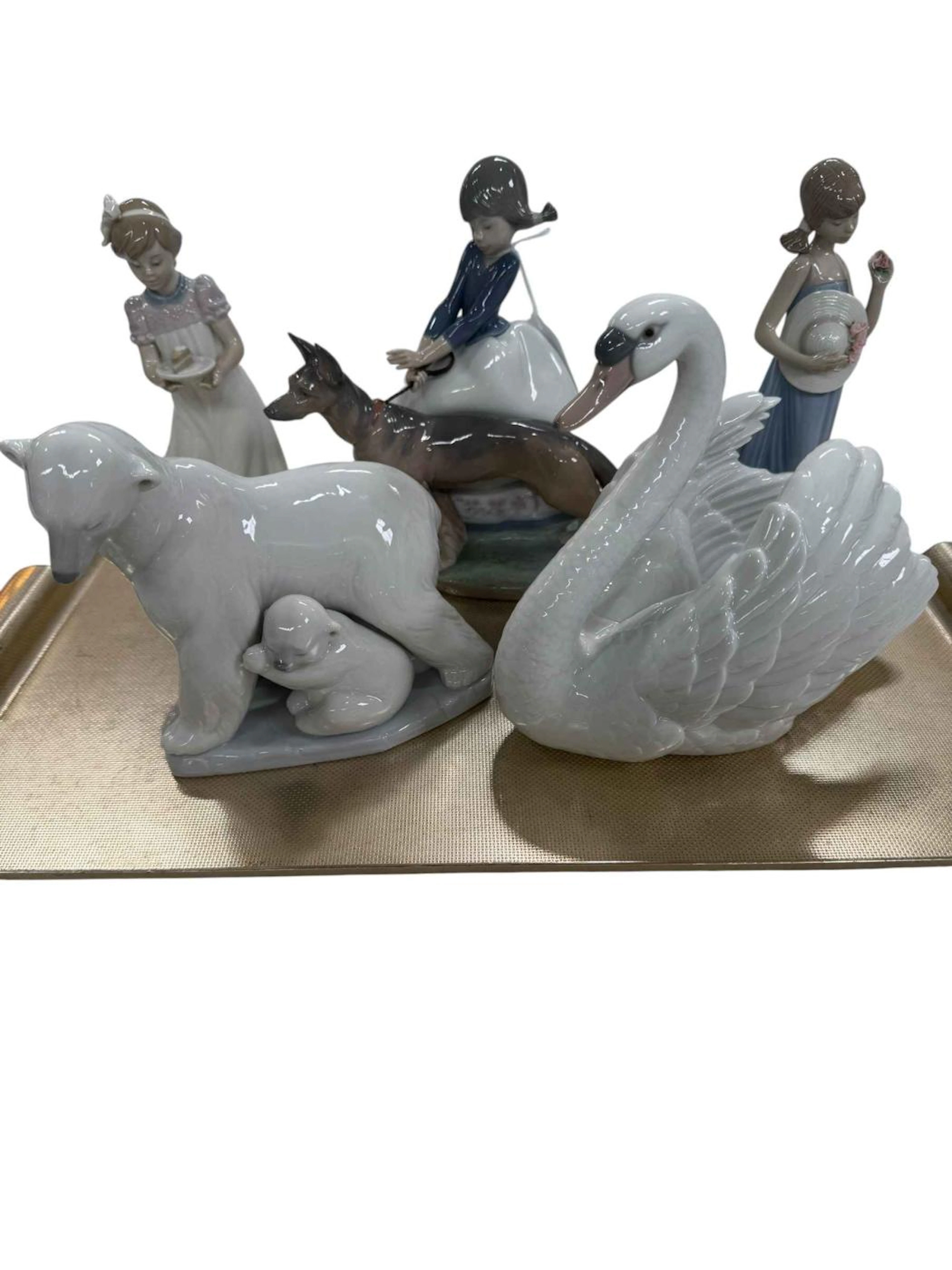 Five Lladro pieces including Polar Bear, Swan and 'Not so Fast'.
