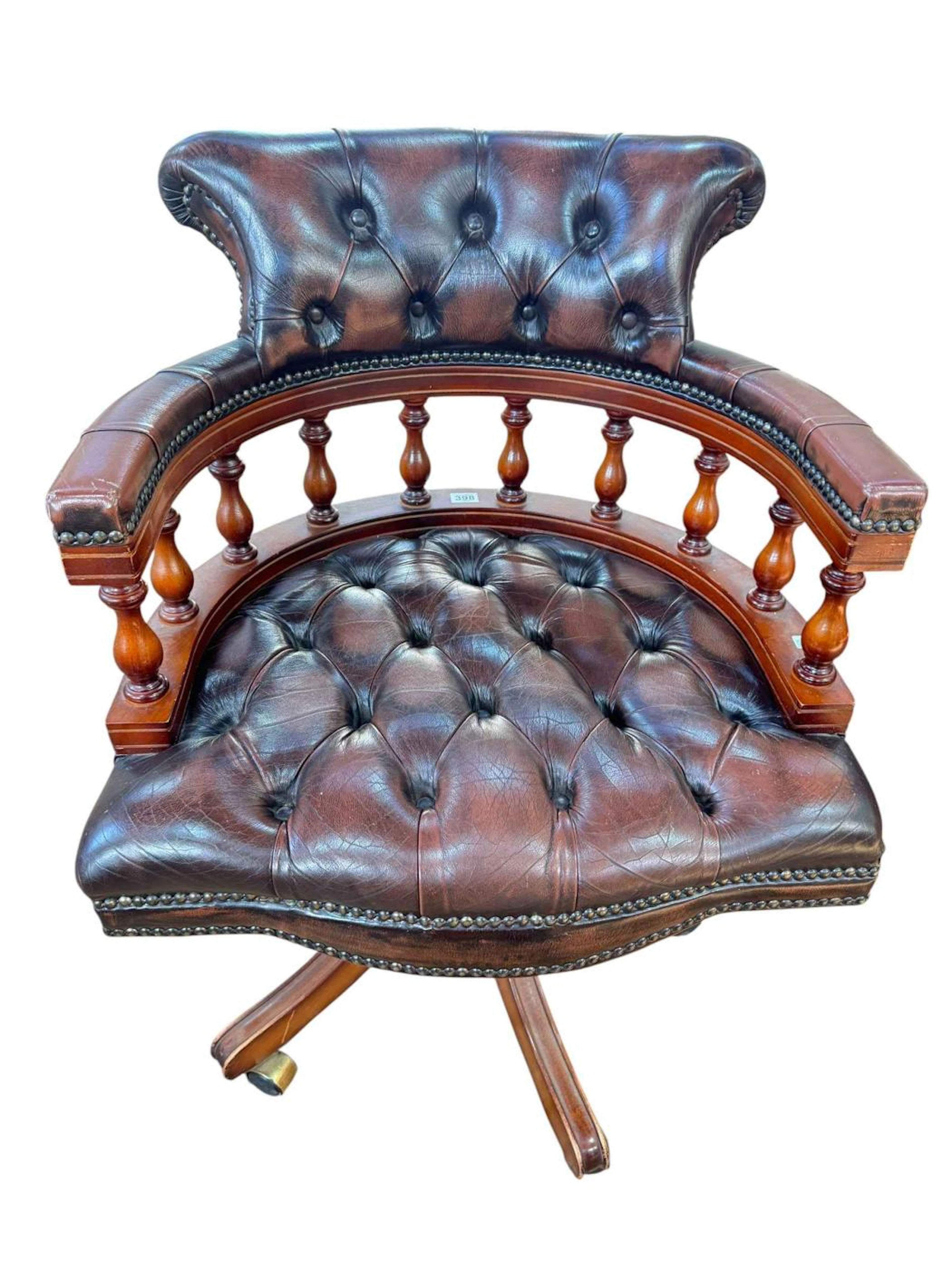 Brown studded leather swivel office chair.