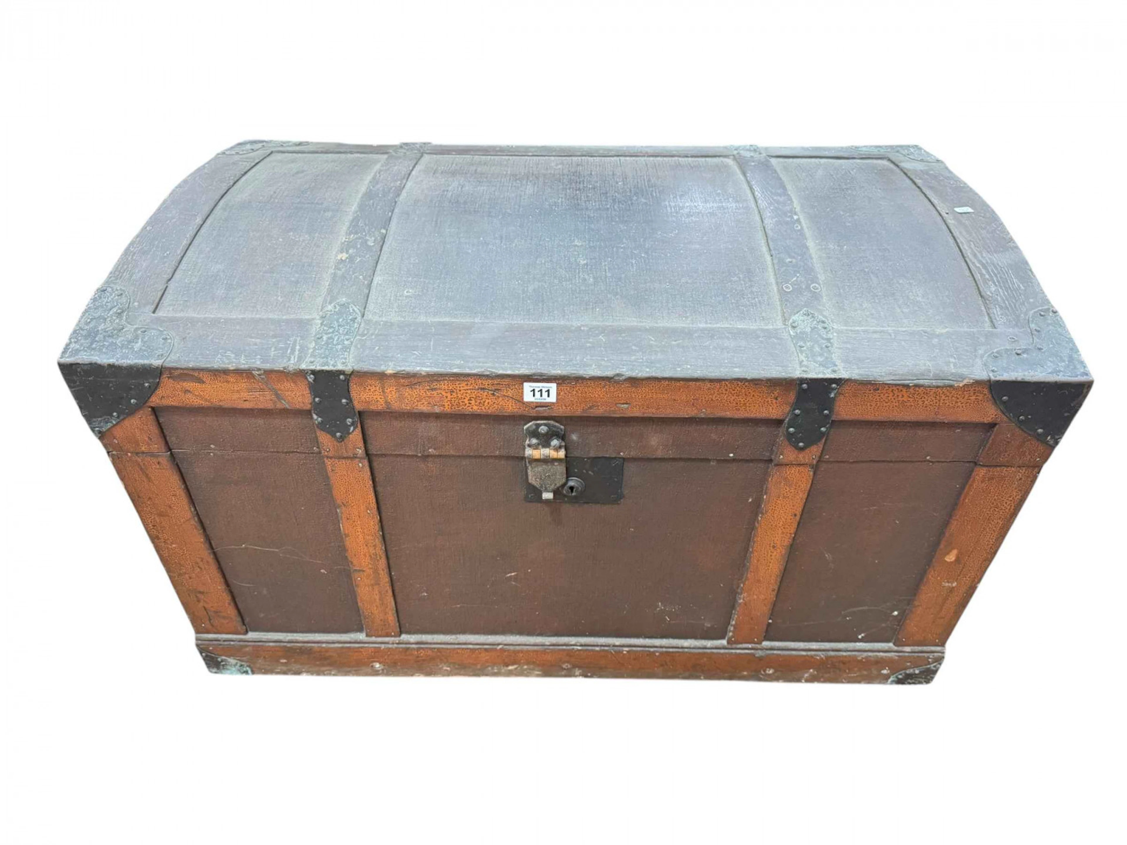 Wooden dome top trunk containing a collection of vintage Christmas