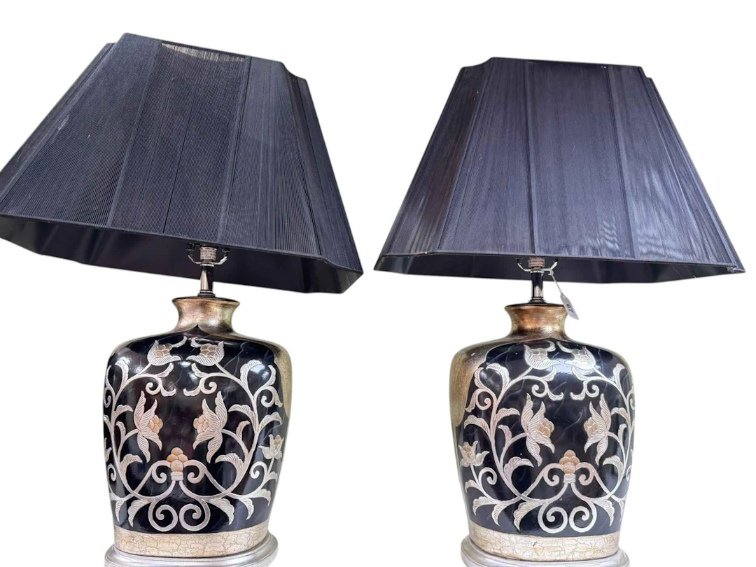 Pair of black and silver floral decorated table lamps and shades.