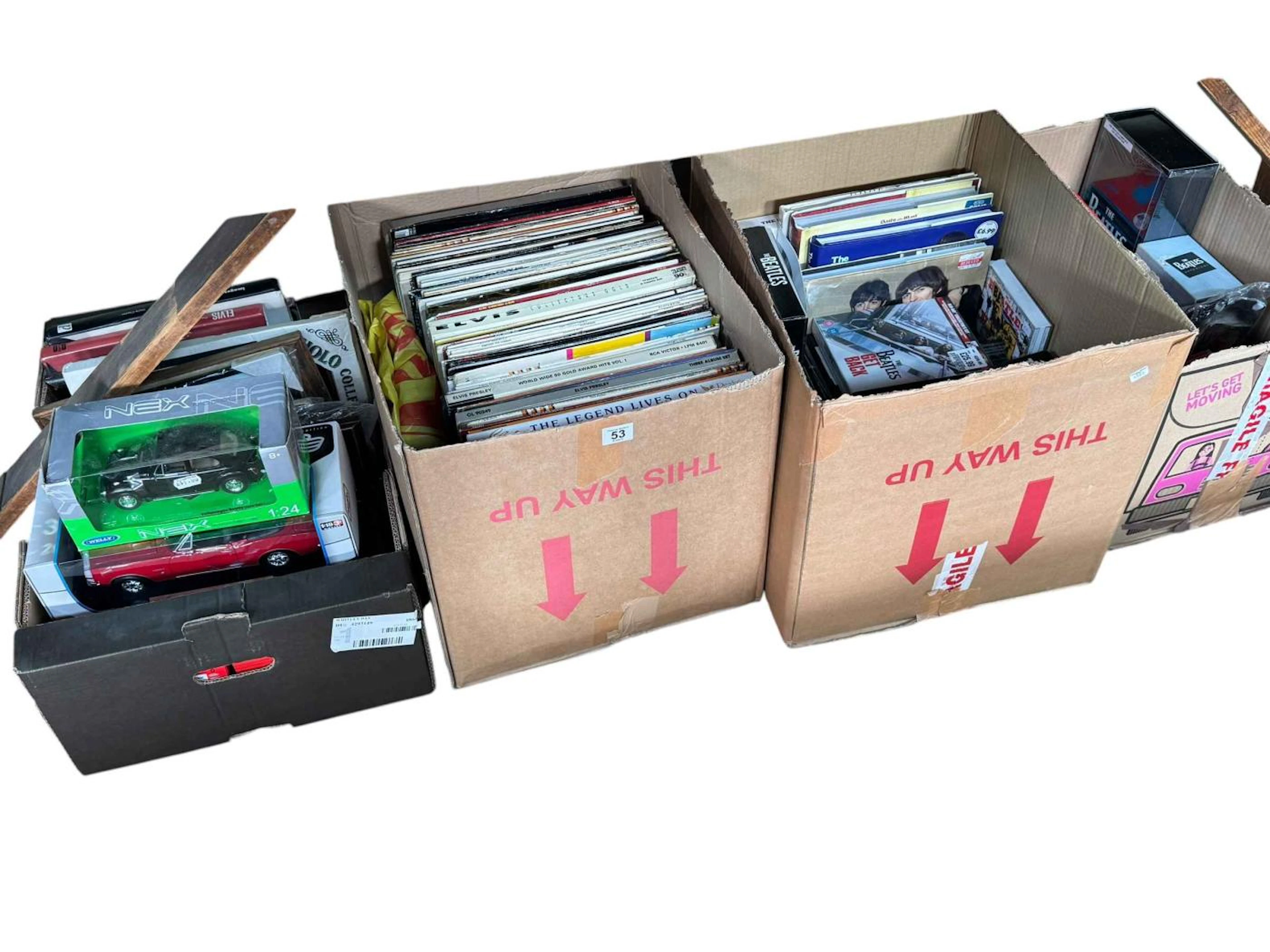 Four boxes of Elvis LP's and Beatles and Elvis memorabilia, model cars, etc.