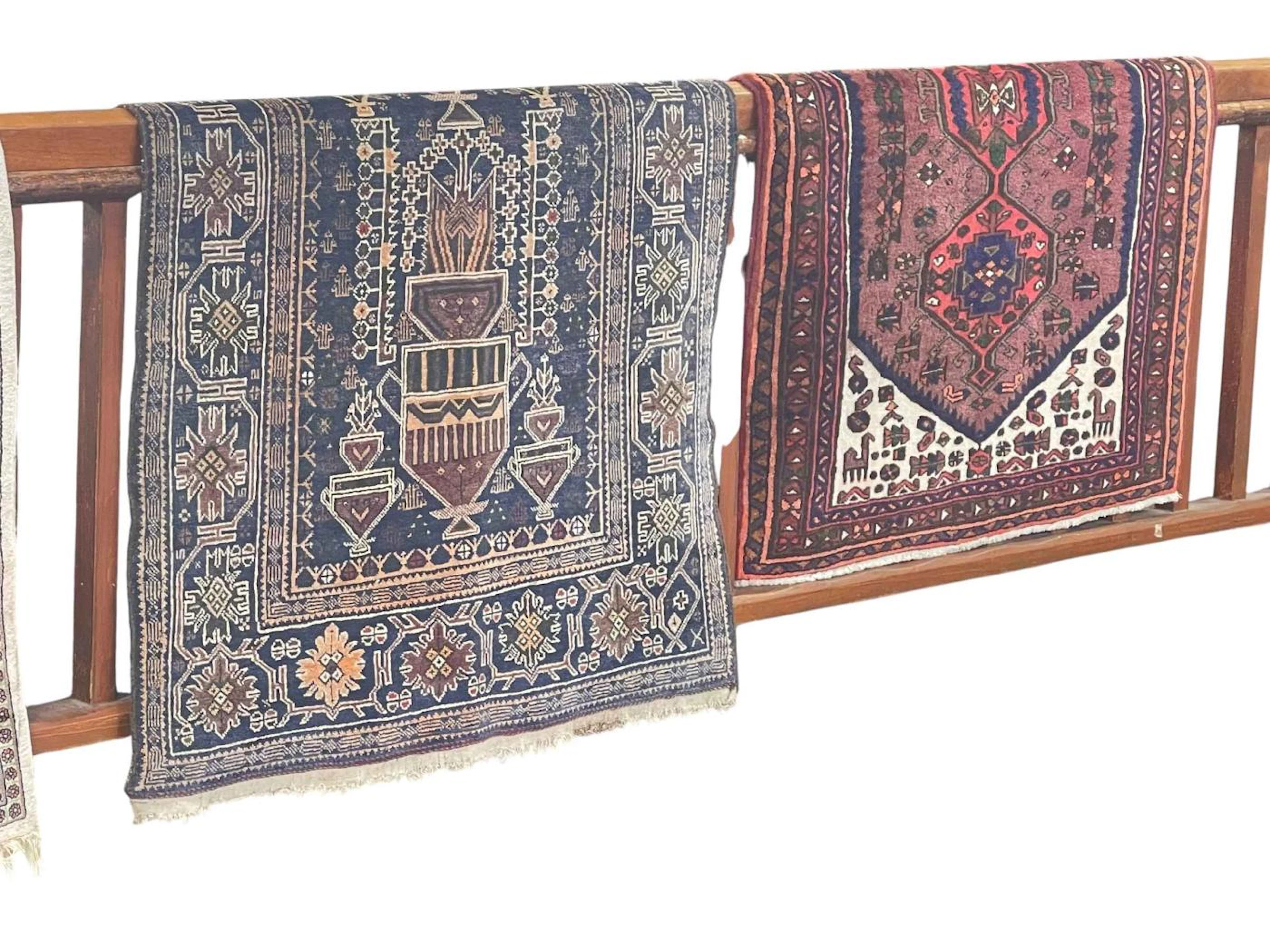 Afghan Baluchi rug featuring tribal design 230cm by 107cm approximately