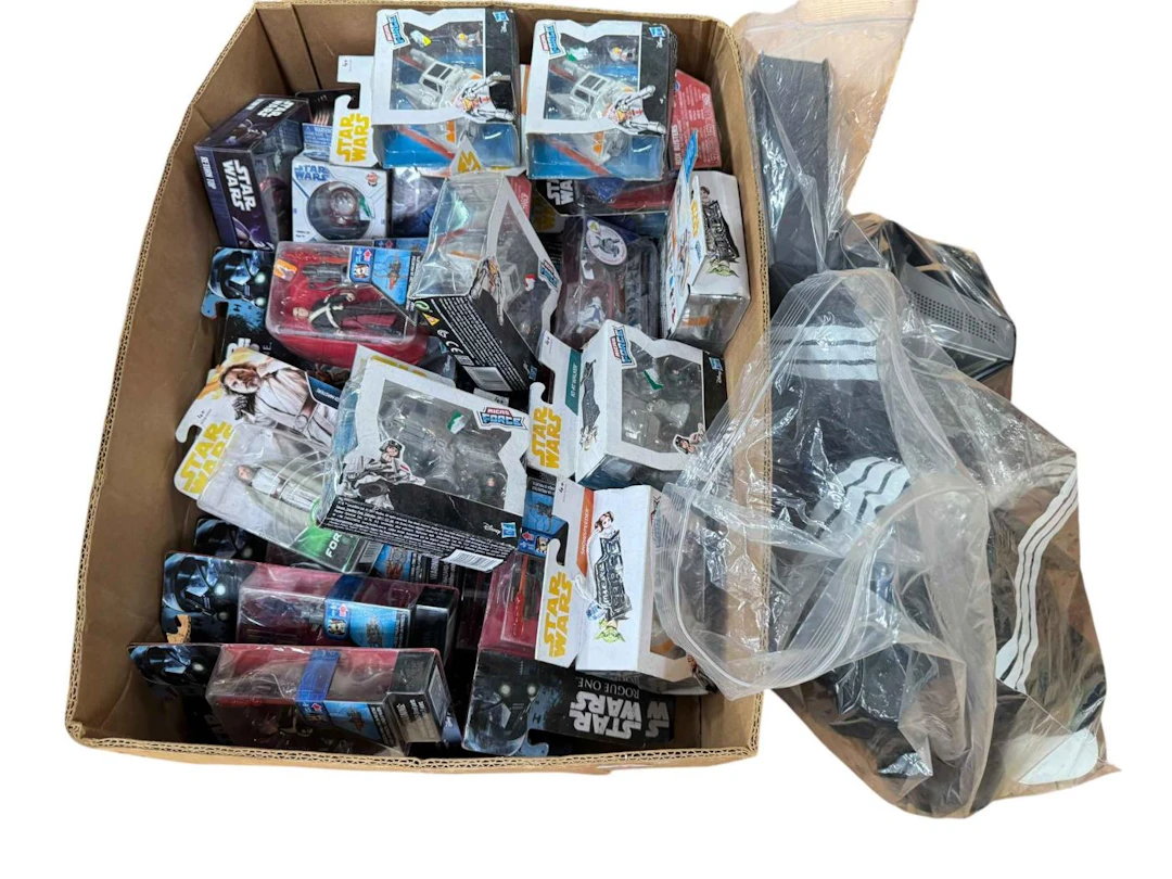 Box of Star Wars character figures, headphones, etc.