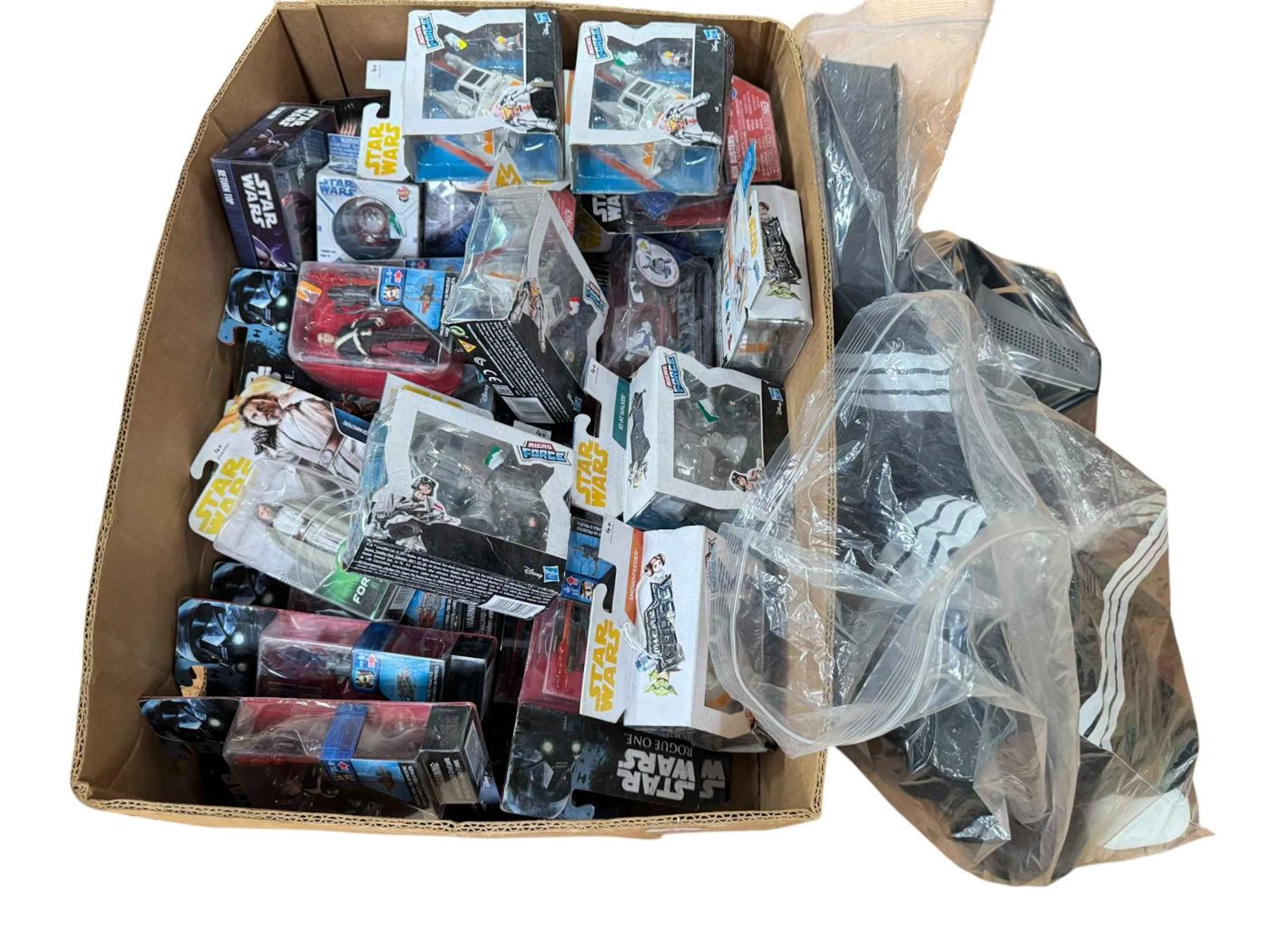 Box of Star Wars character figures, headphones, etc.