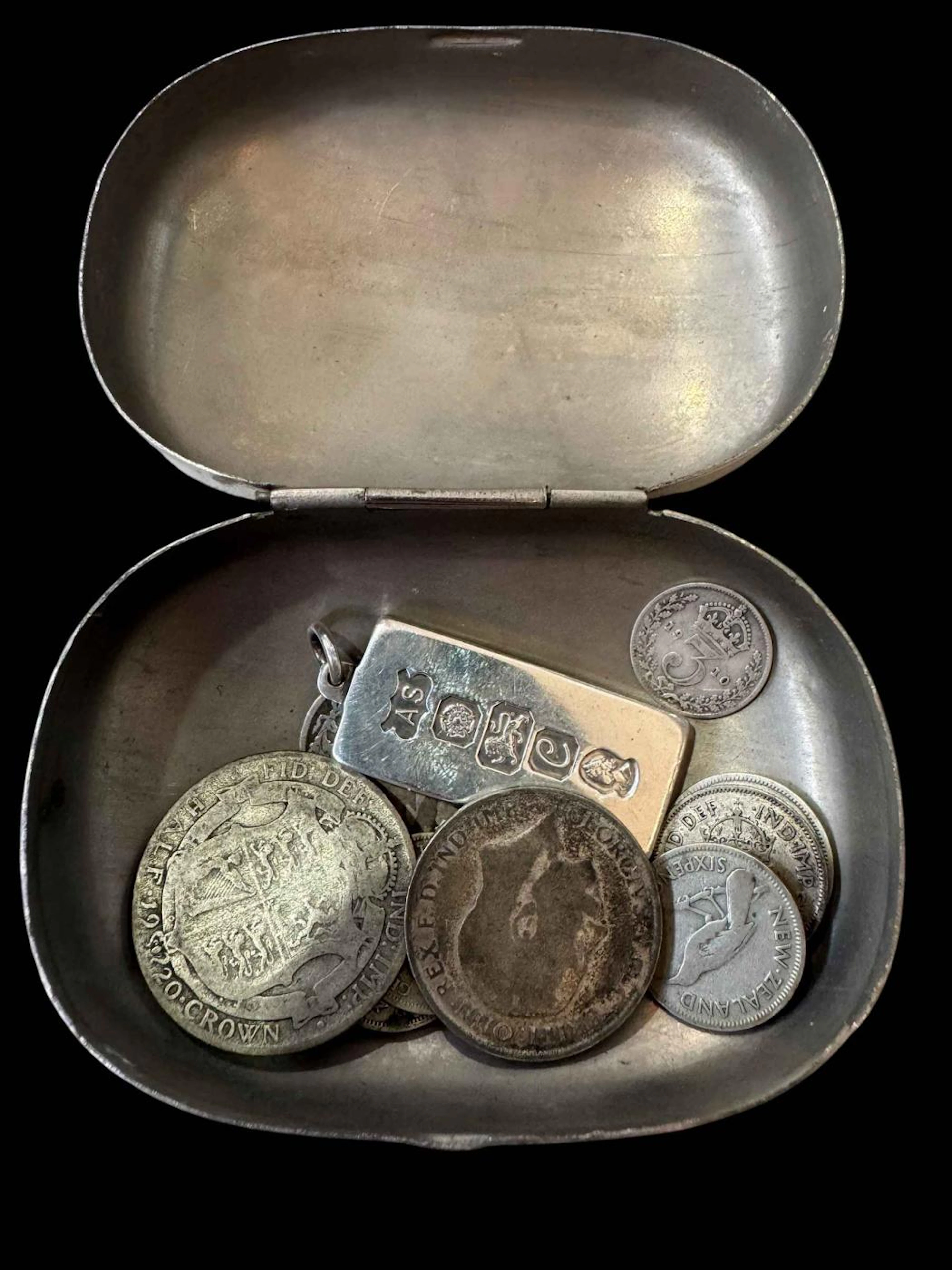 Small box with silver ingot and coinage.