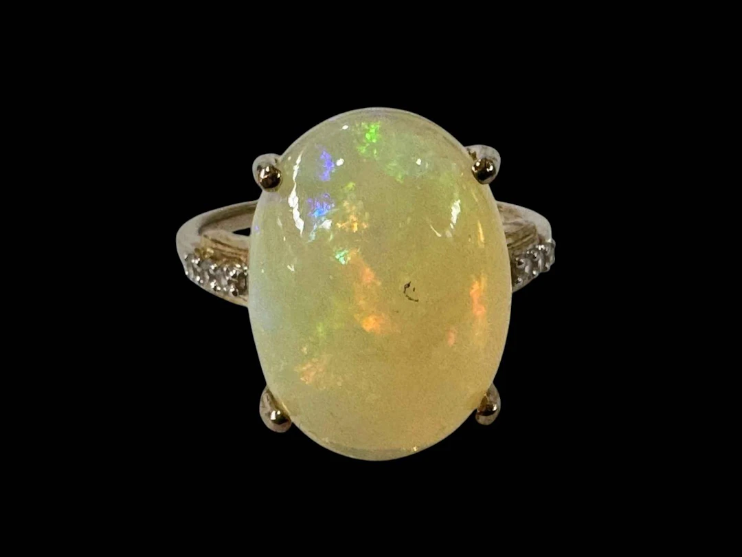 Large opal 9k gold ring with diamond set shoulders, size N/O.