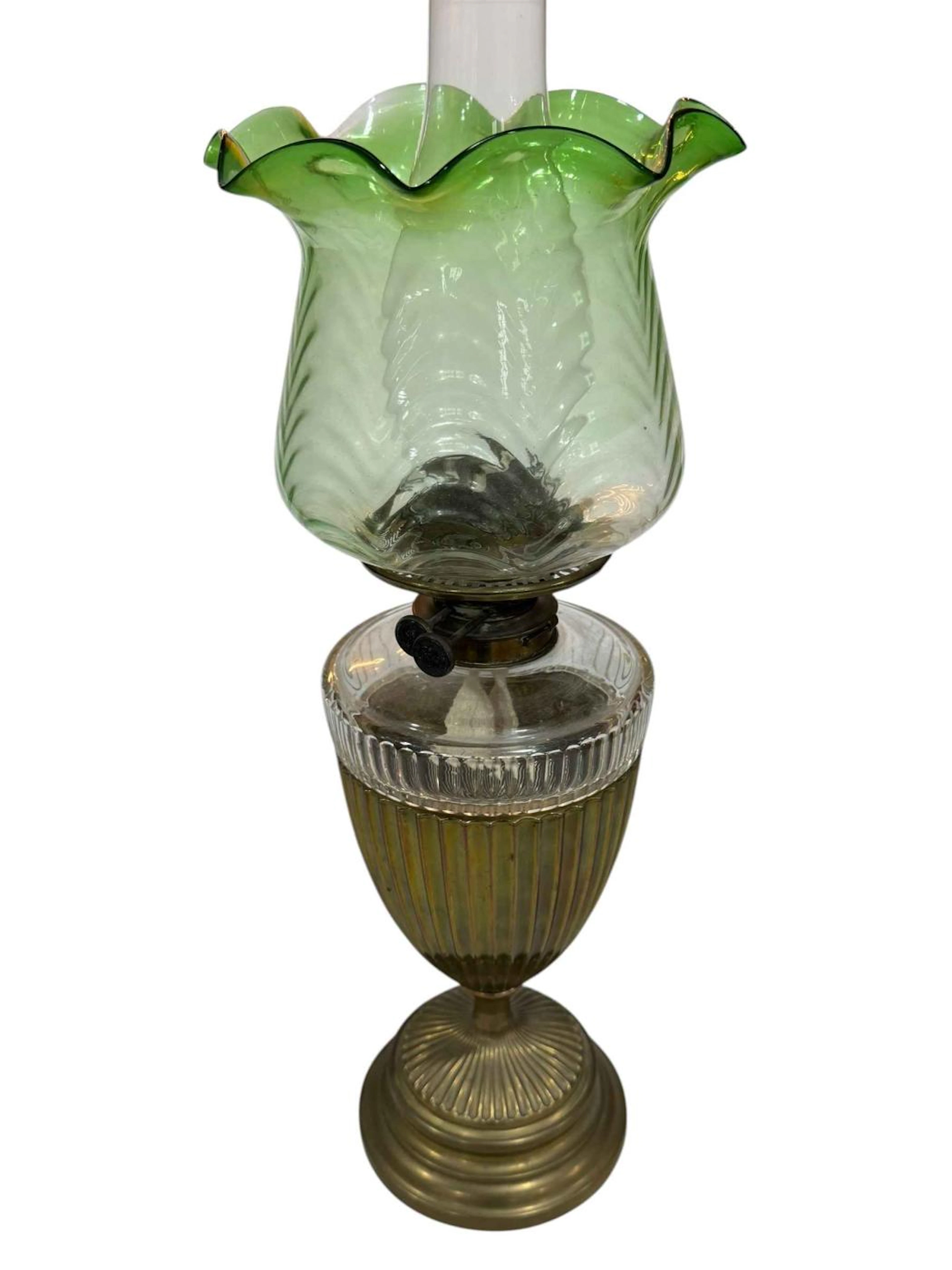 Edwardian brass and glass oil lamp with green tinted shade.