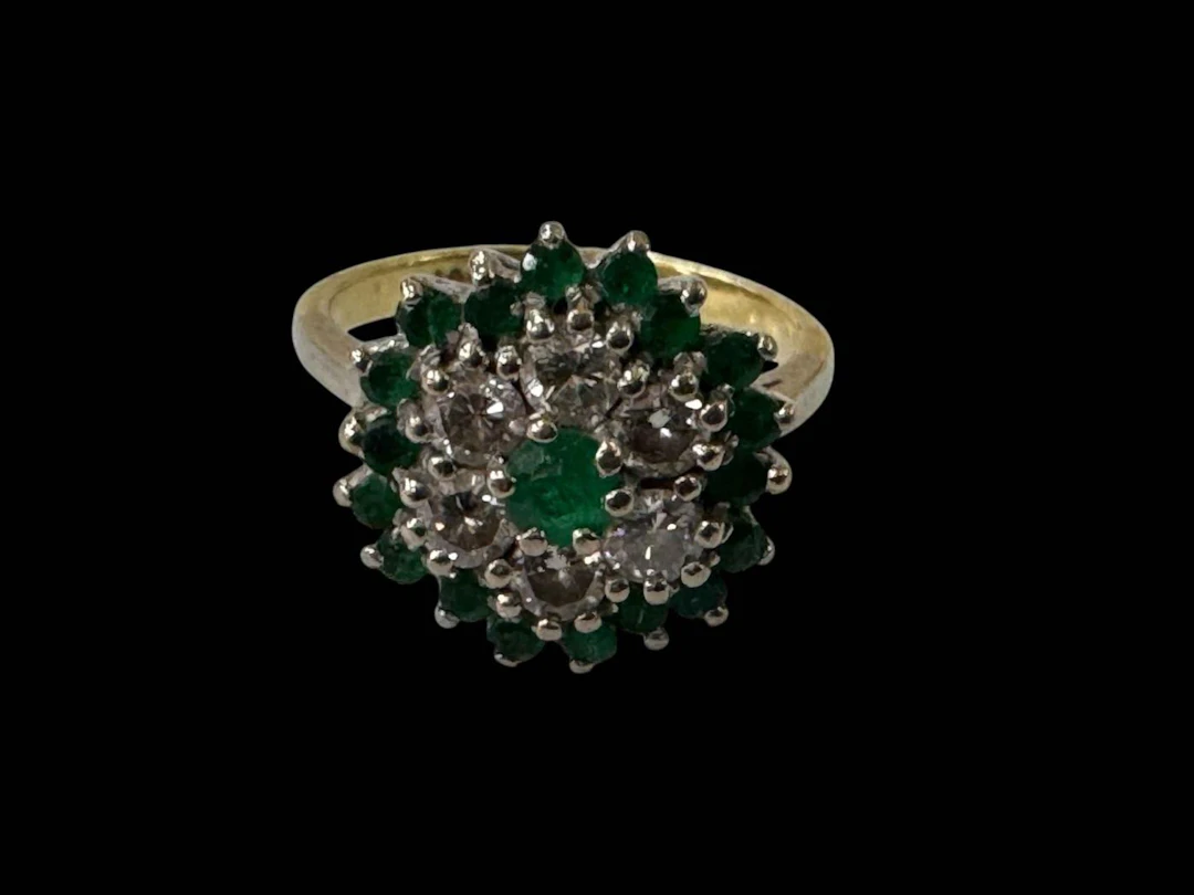 Emerald and diamond cluster 18 carat gold ring, twenty five stones