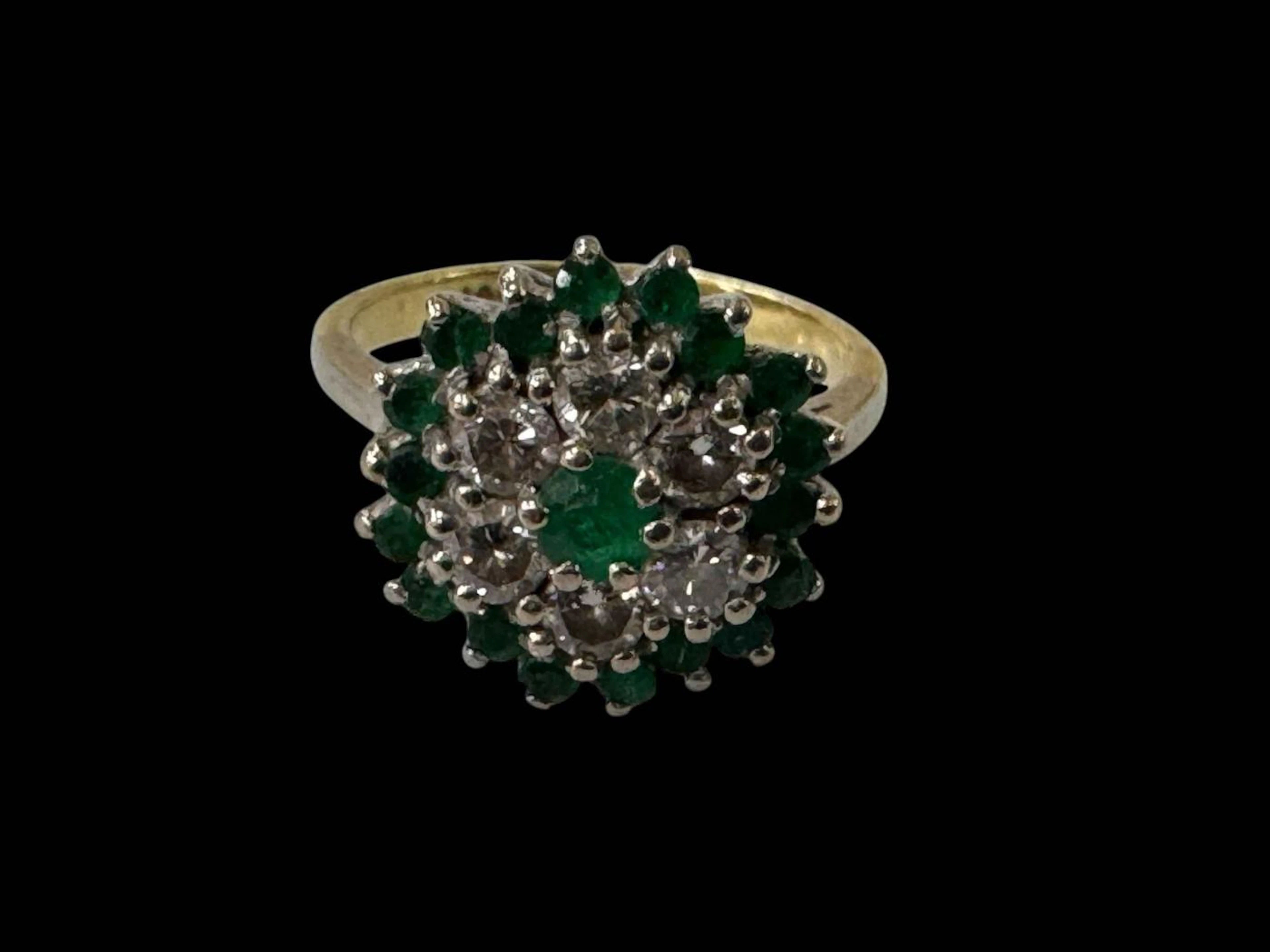 Emerald and diamond cluster 18 carat gold ring, twenty five stones