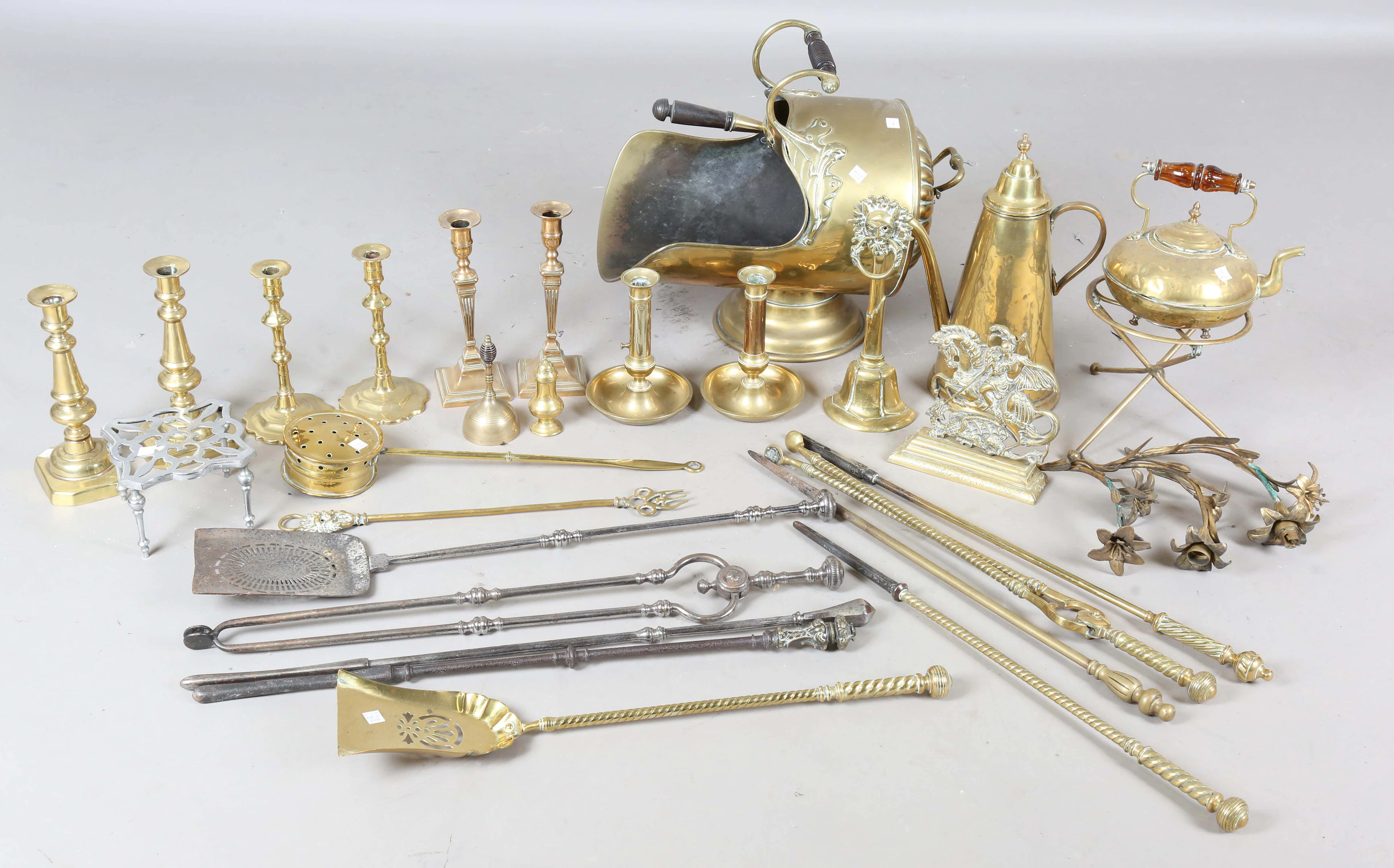 A collection of brassware, including two Victorian brass doorstops