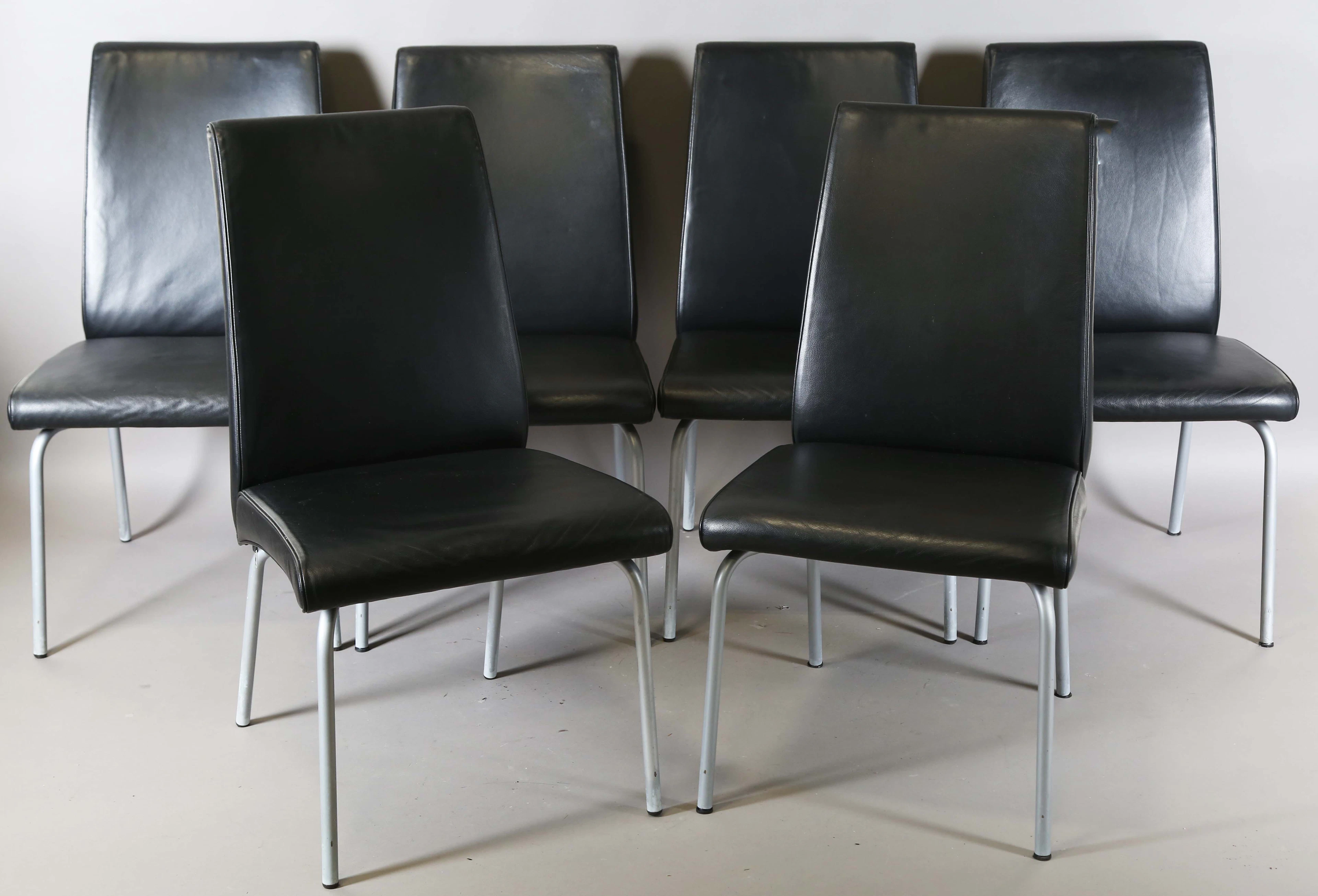 A set of six modern black leather and tubular metal dining chairs
