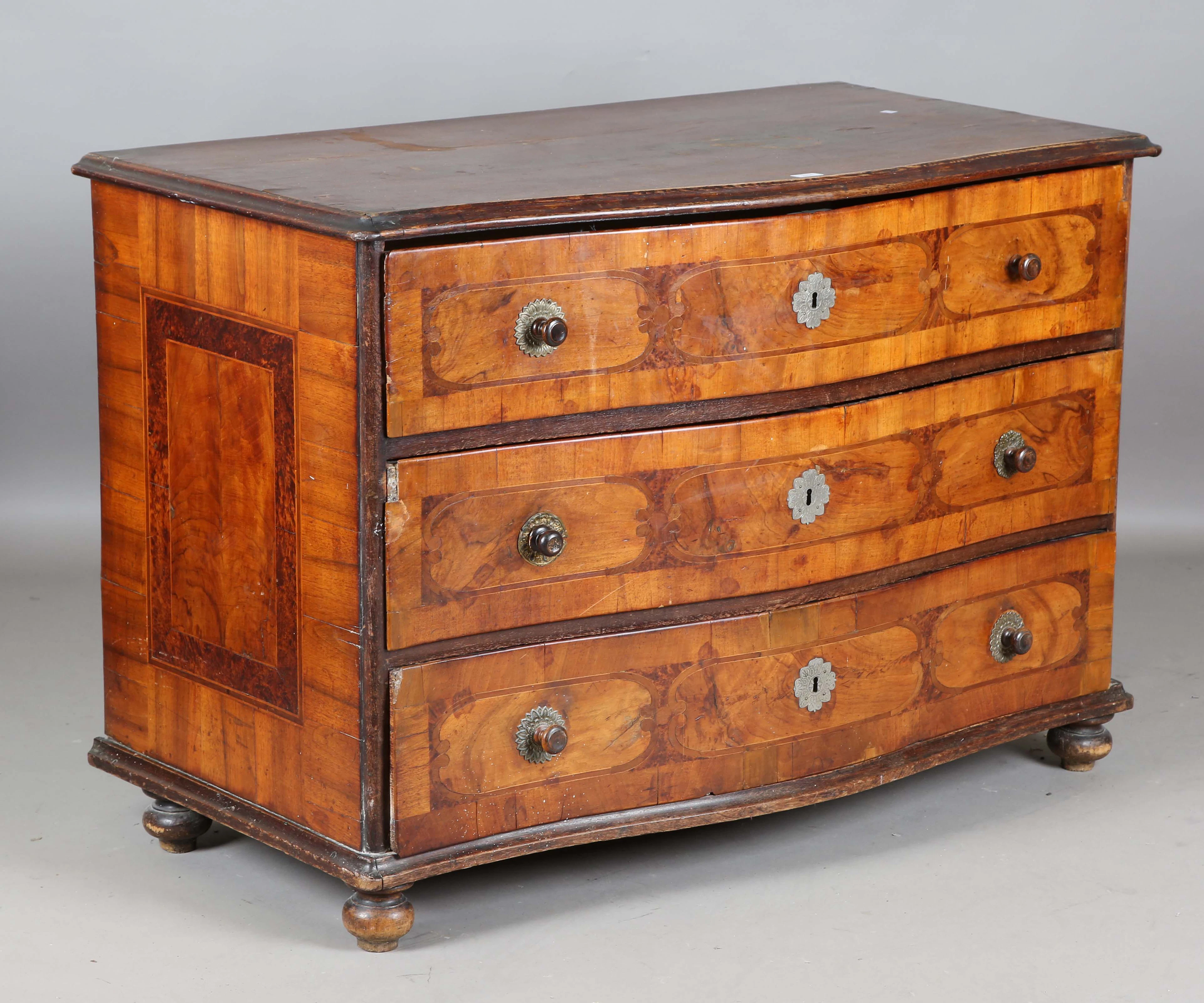 An 18th century South German walnut three-drawer commode with serpentine-fronted