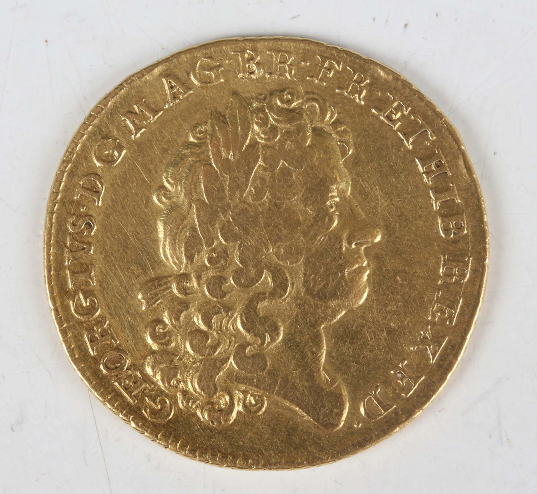 A scarce George I guinea 1714, first laureate head, Sp 3628 (good/fine).