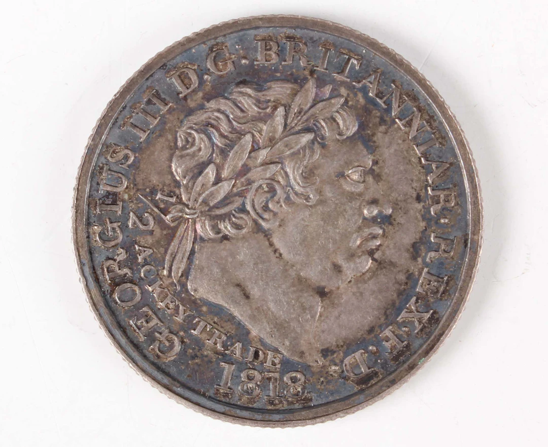A scarce Gold Coast George III half-ackey 1818 (extremely fine, toned