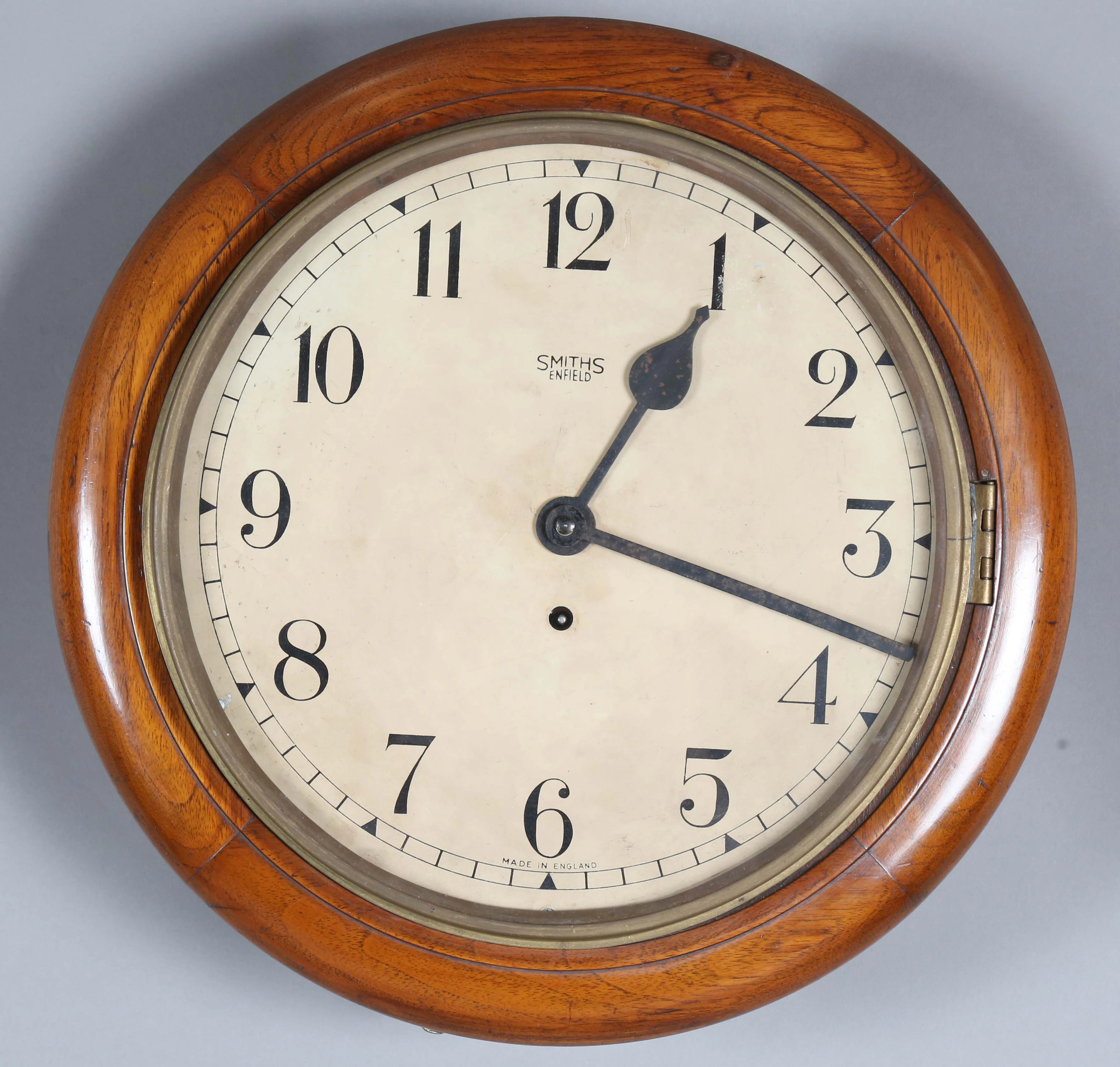 An early 20th century walnut circular cased wall timepiece, the 12-inch