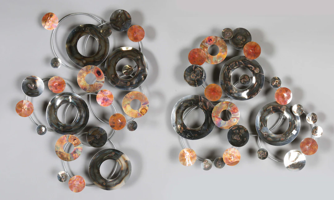 A pair of modern anodized and polished metal wall appliqués, length