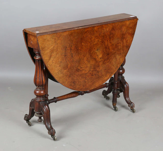 A mid-Victorian burr walnut oval Sutherland table, raised on twin