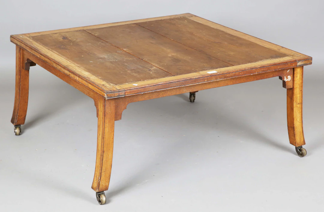 An early Victorian oak framed square display stand or coffee table