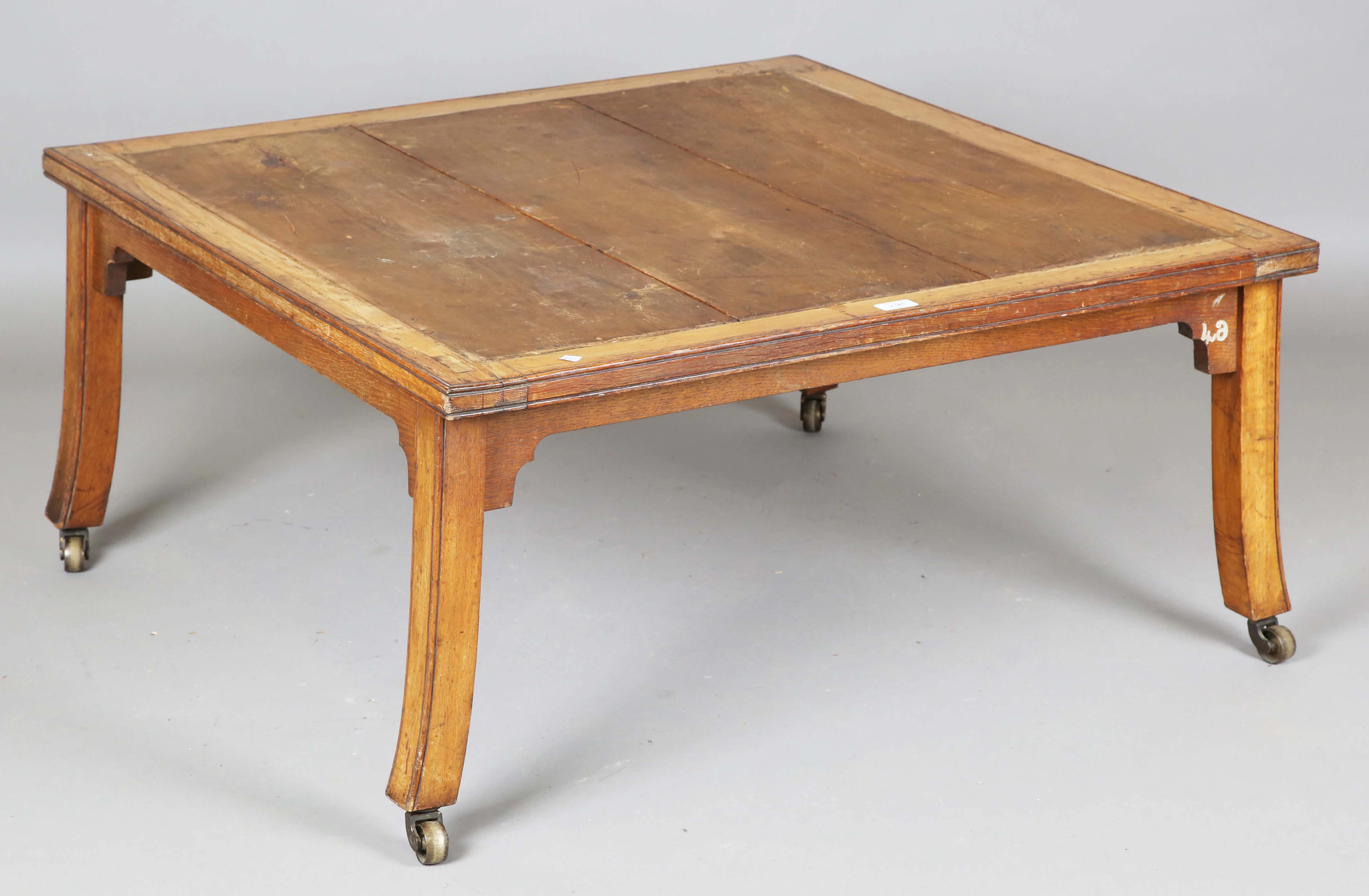 An early Victorian oak framed square display stand or coffee table