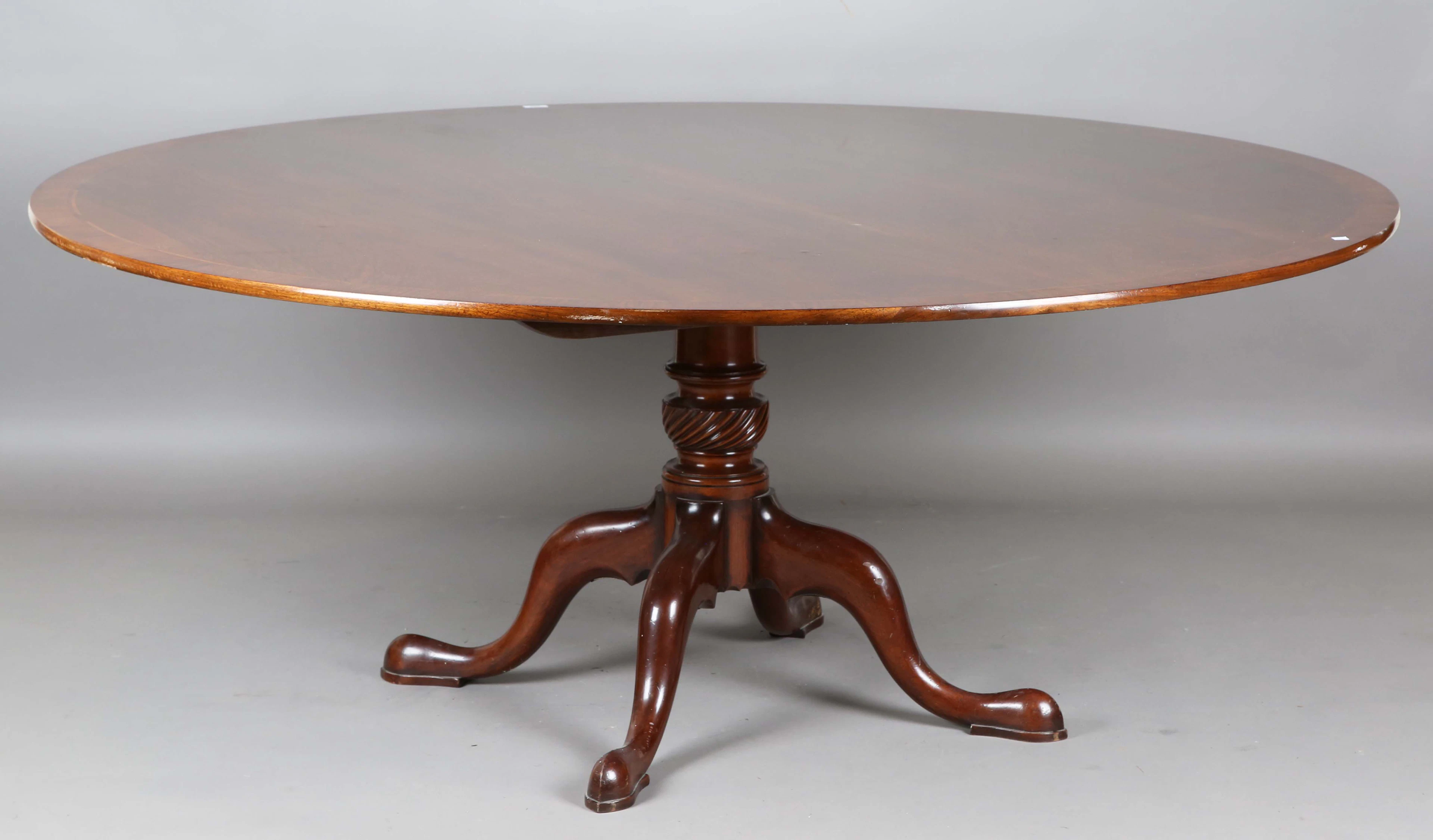 A modern George III style mahogany circular dining table, in the manner