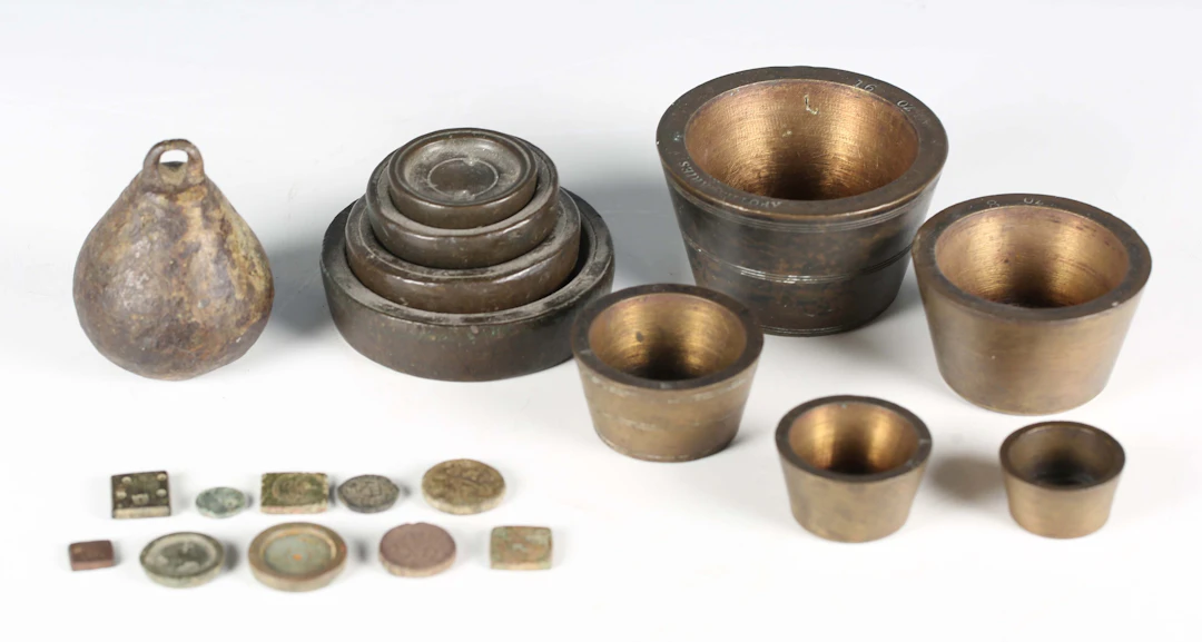 A group of various weights, including a 14th century steelyard arm