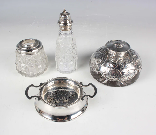 A George VI silver tea strainer and stand, Birmingham 1946 and 1947