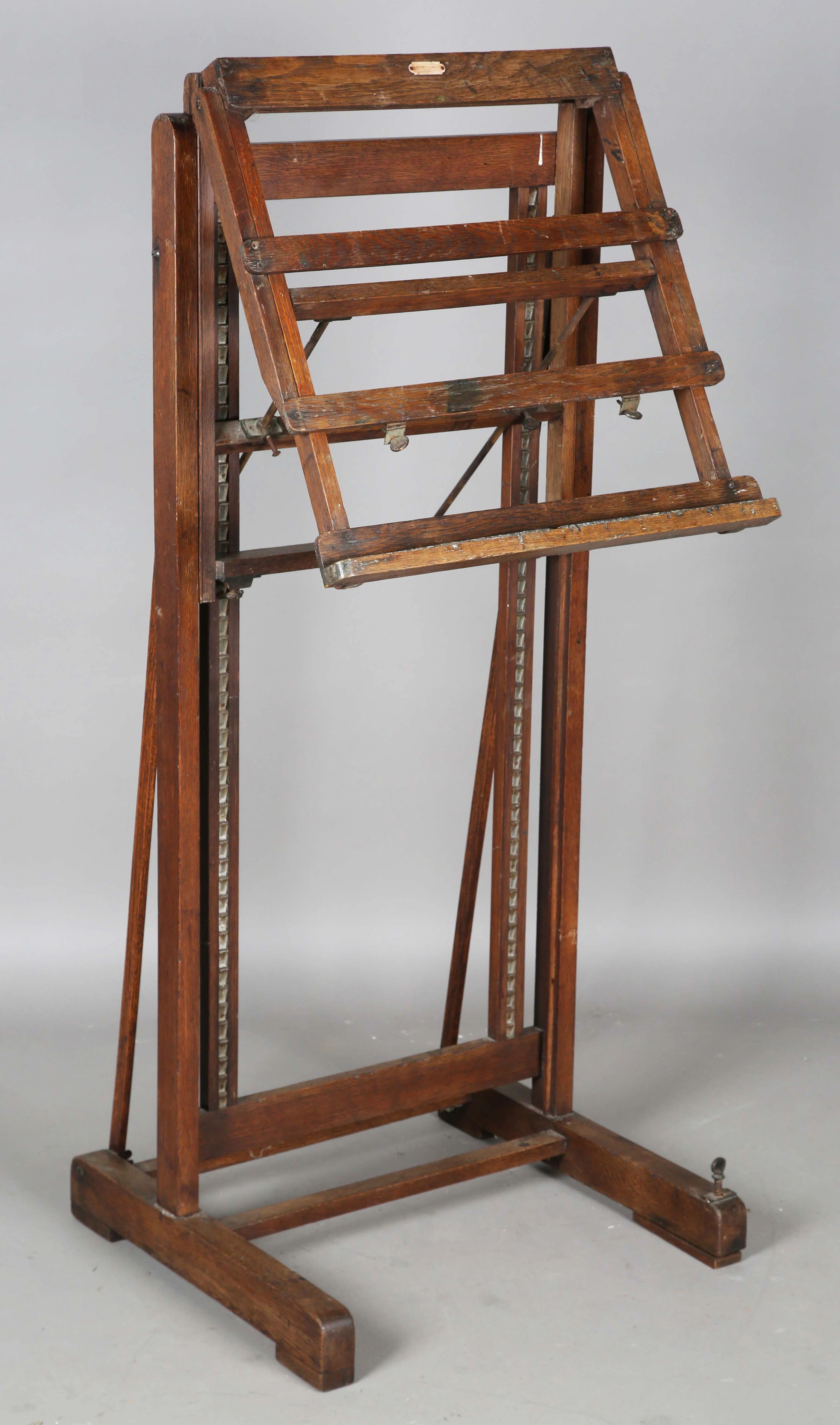 An early 20th century oak framed artist's easel with adjustable stand