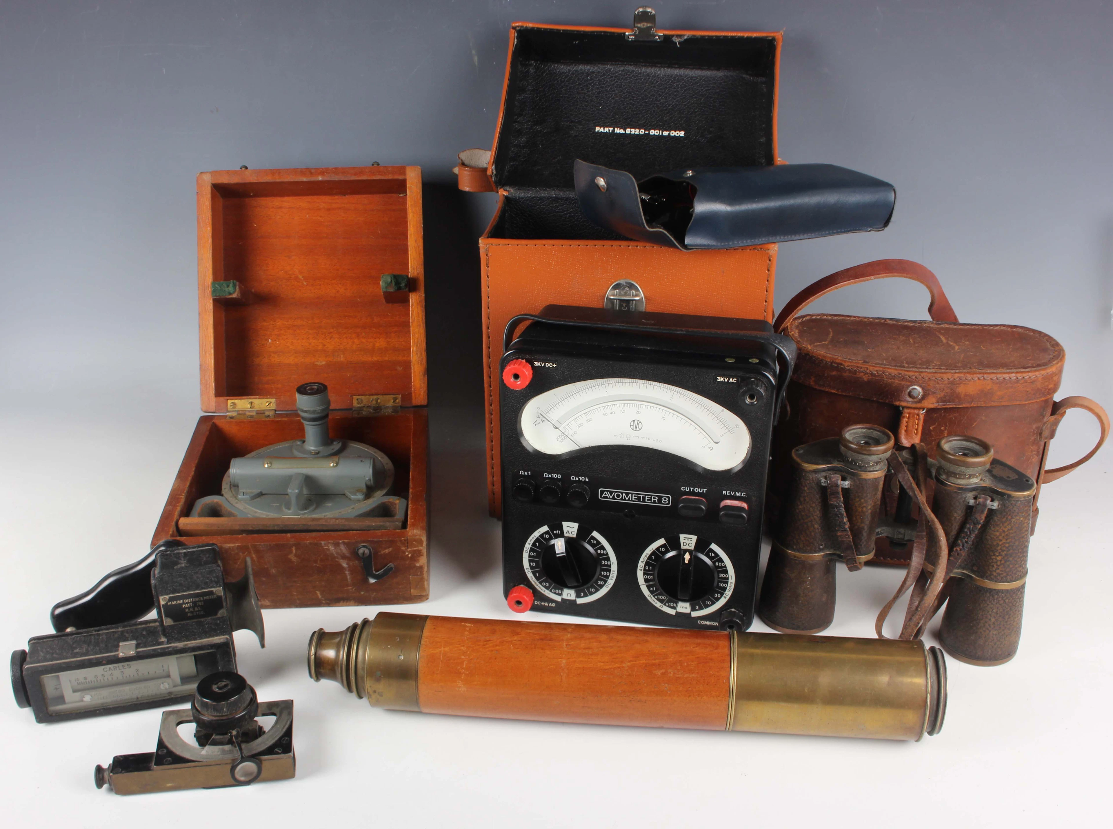 An early 20th century mahogany and gilt lacquered brass two-draw telescope