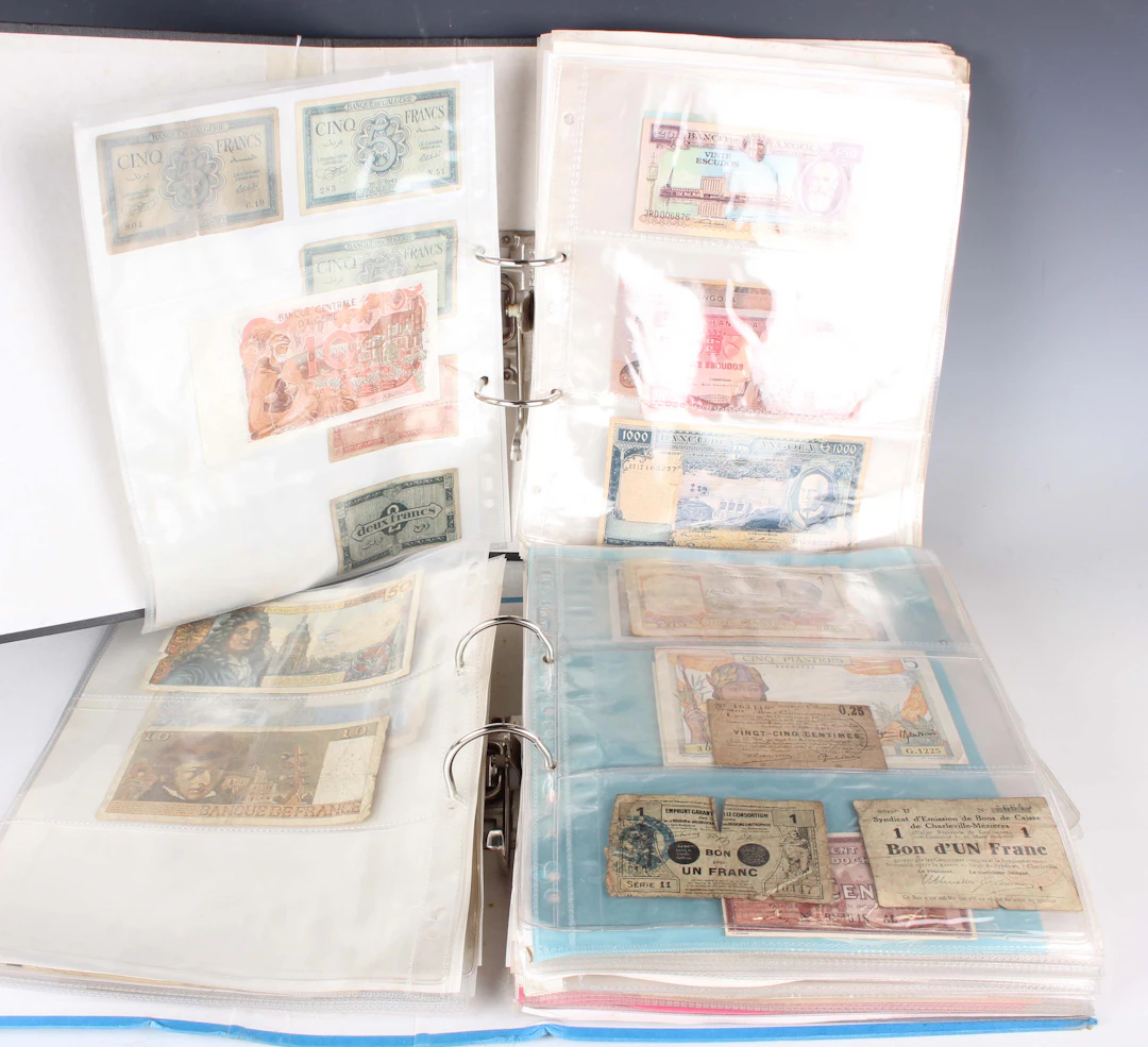 A large collection of European and world banknotes, including a large