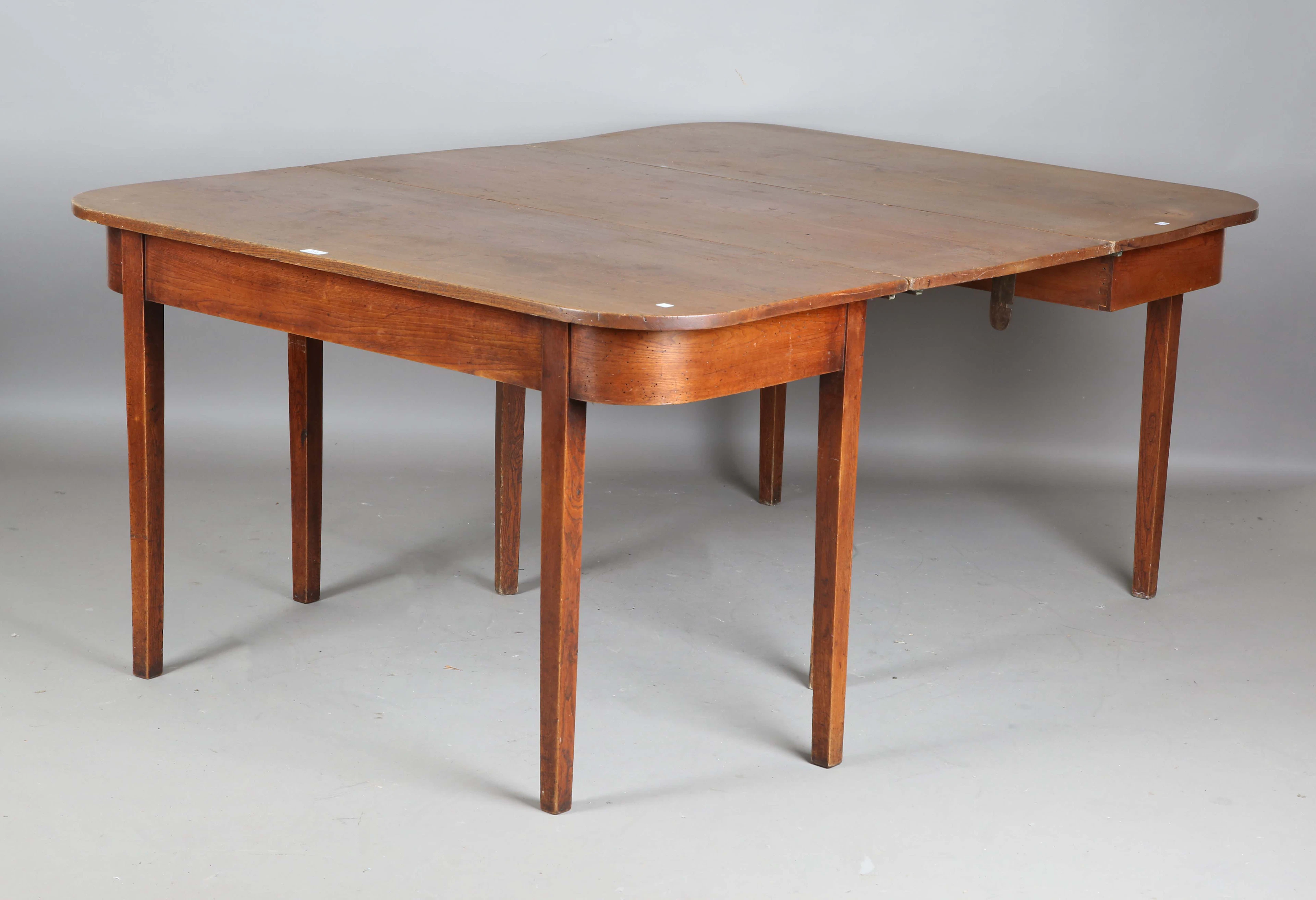 A George III provincial elm 'D' ended dining table with single extra