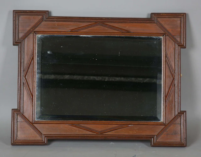 A late 19th century French walnut rectangular wall mirror with projecting
