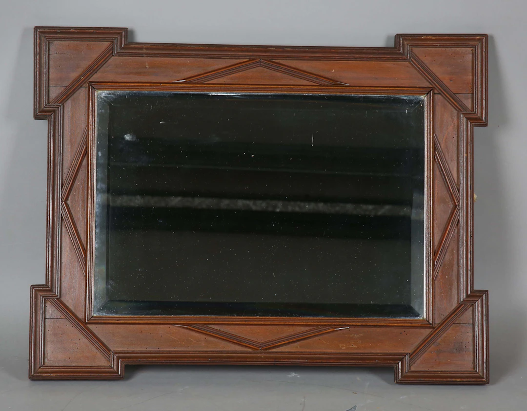 A late 19th century French walnut rectangular wall mirror with projecting