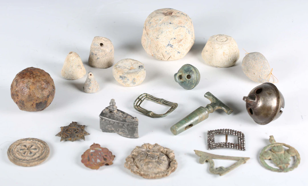 A large collection of mixed metal detector finds, including Roman
