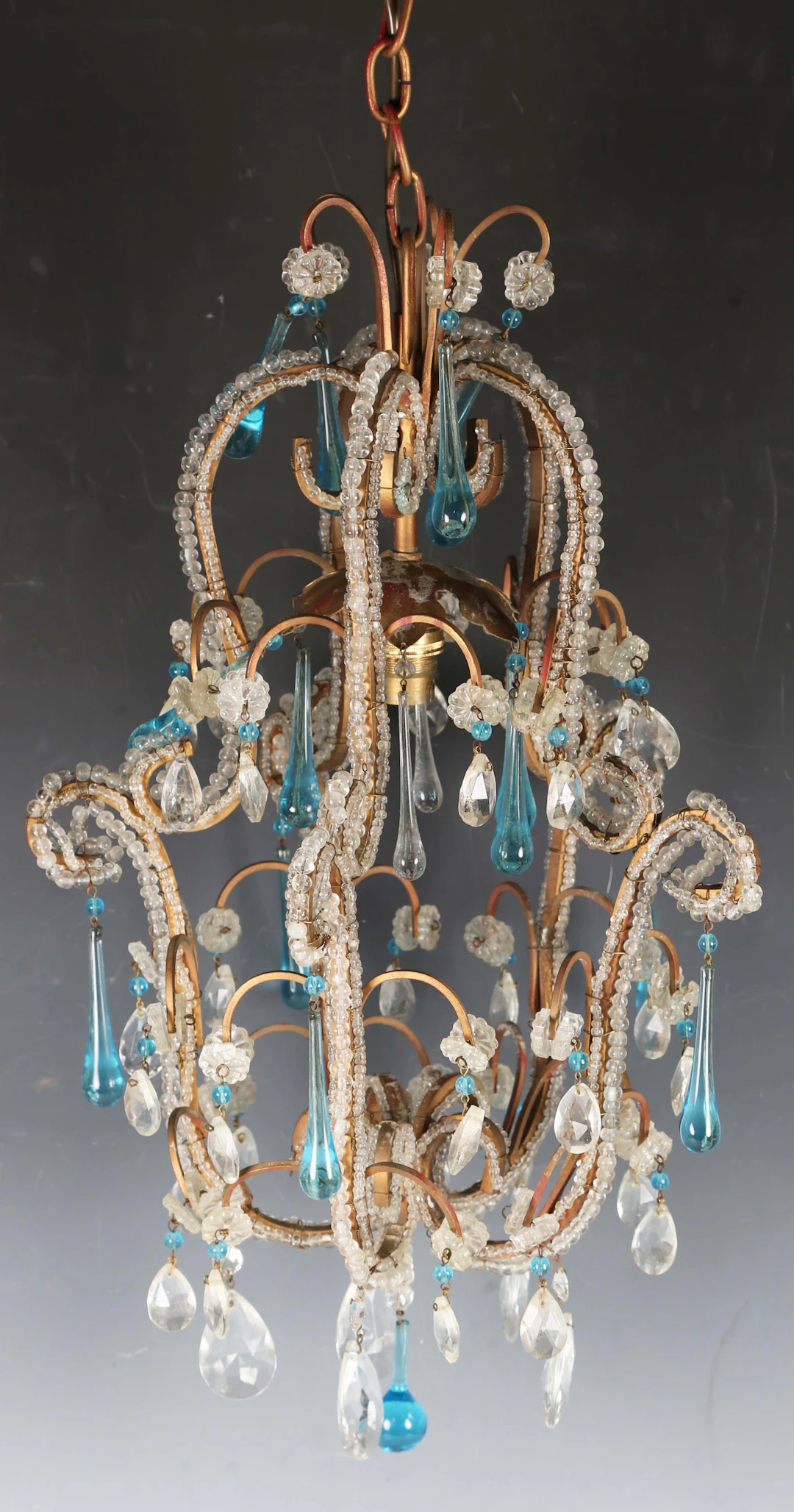 A mid-20th century clear glass and wirework ceiling light, hung with